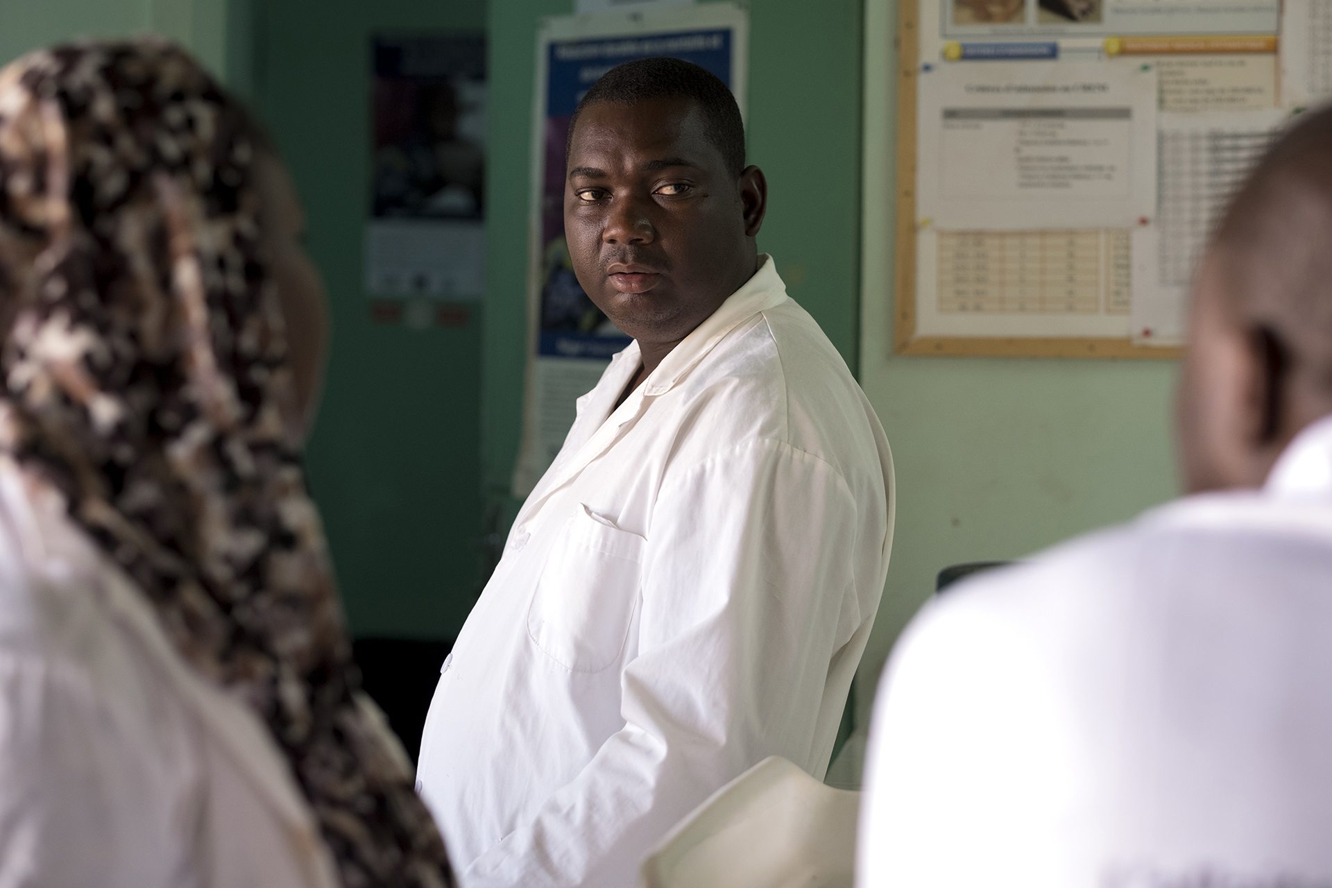 A doctor in a white smock in a medical room