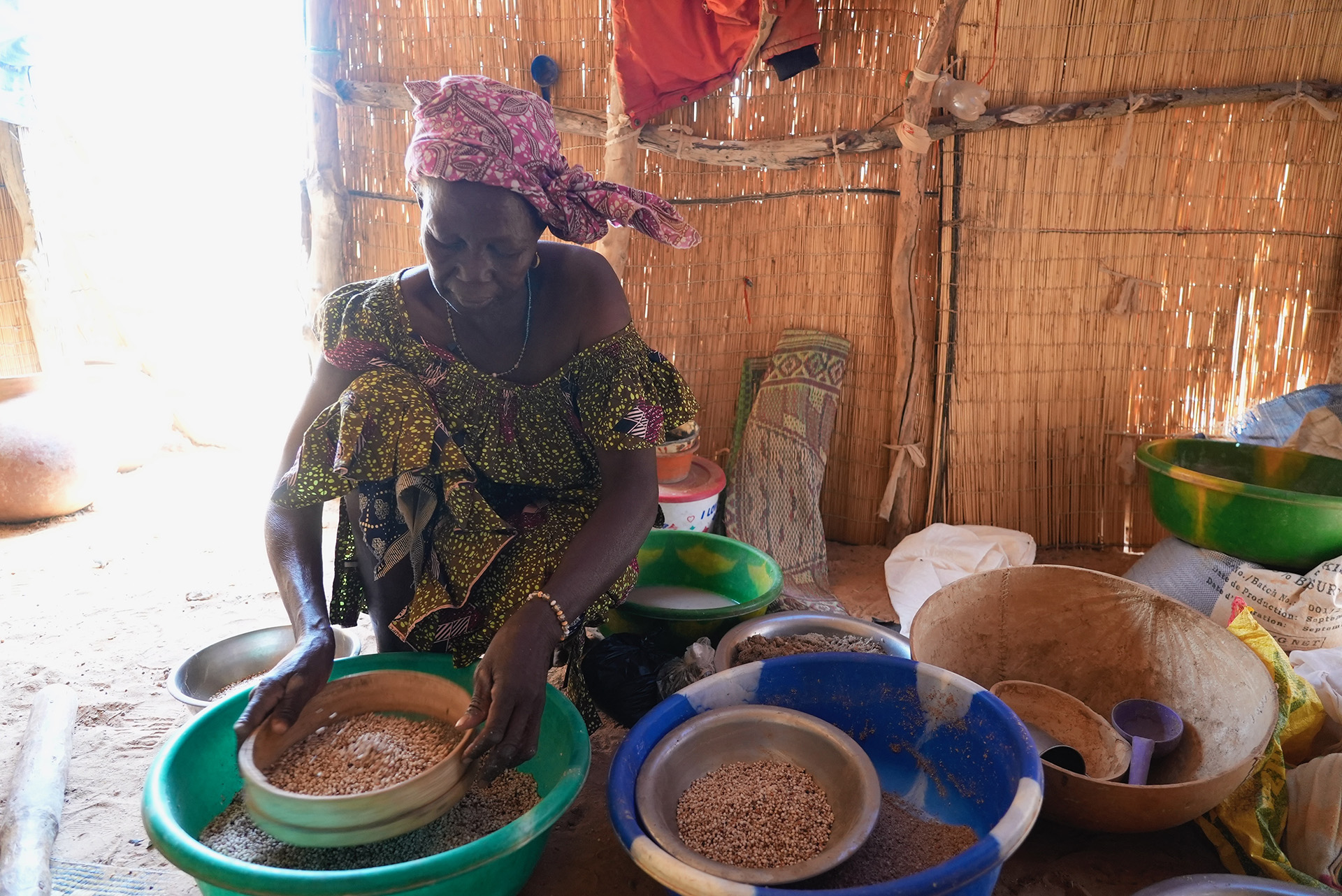  A woman sorts through grains in the northern town of Djibo. The town’s population has grown from 60,000 to around 300,000 during the conflict. 