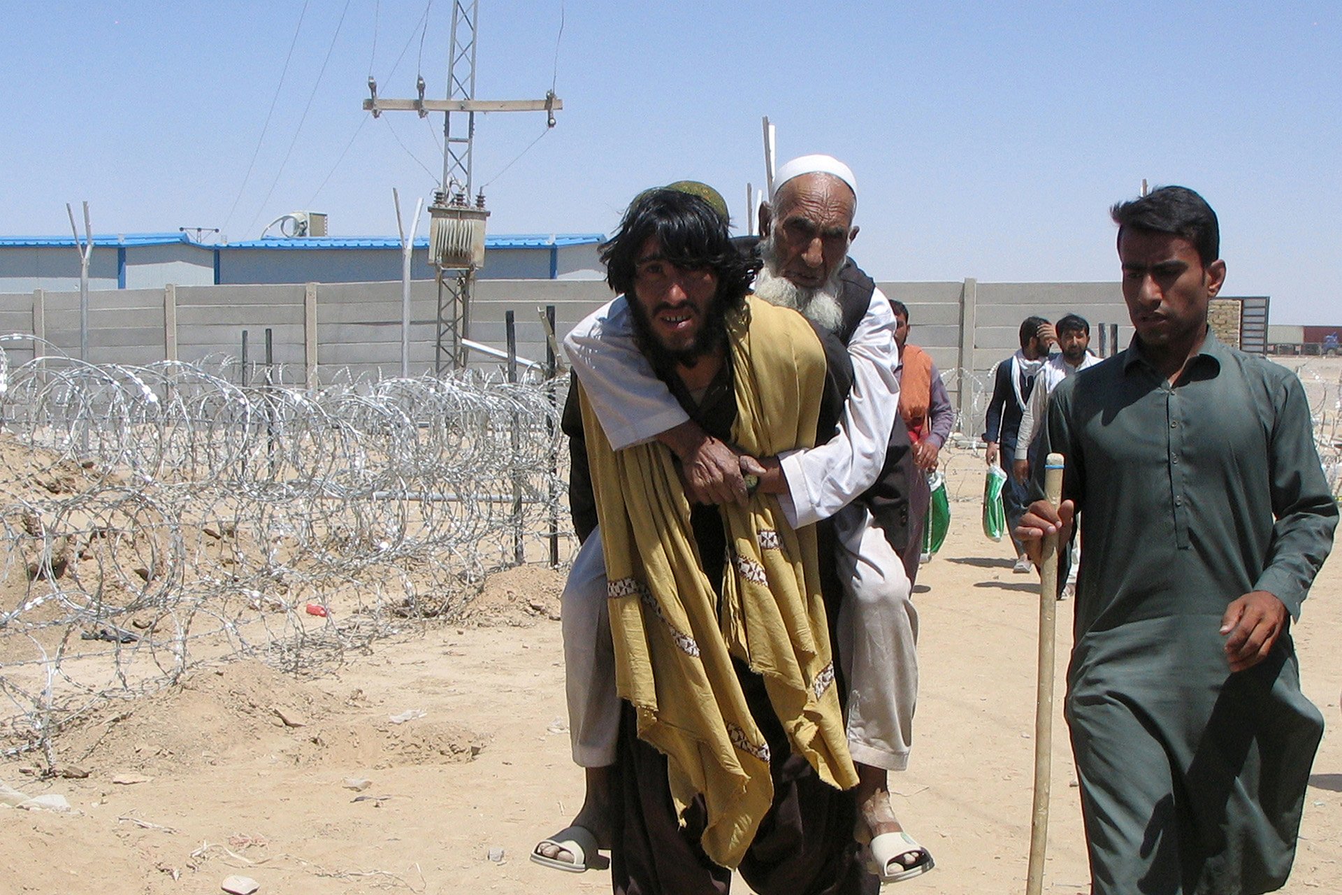  People crossing the border from Afghanistan to the town of Chaman in Pakistan last August. In the year since, restrictive and harsh policies have made it difficult for Afghans to seek safety and economic reprieve outside the country.