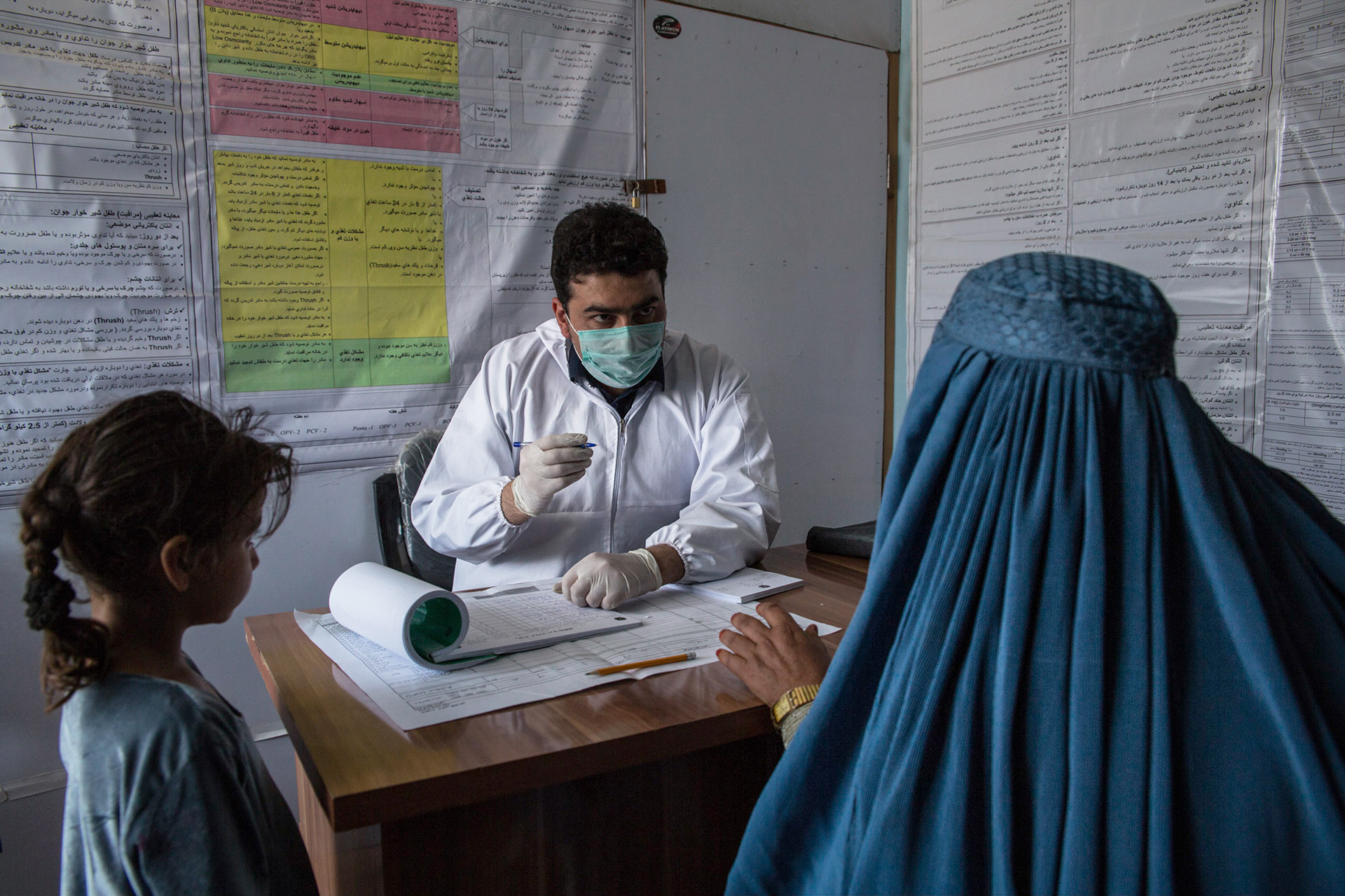 A woman and her daughter speak to Dr. Mohammed Edris