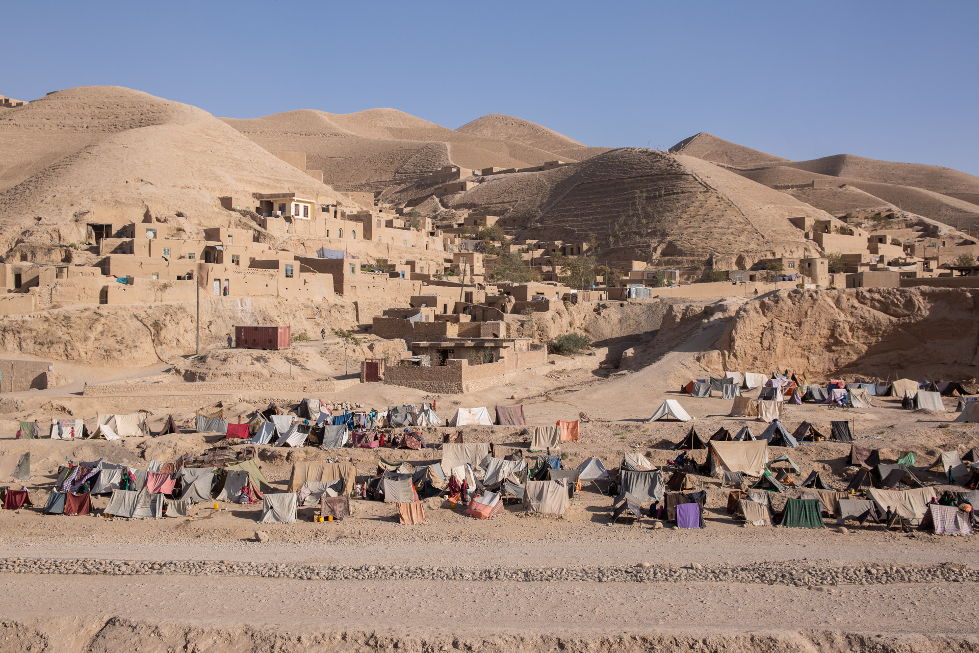 A landscape of tents on a sandy mountain