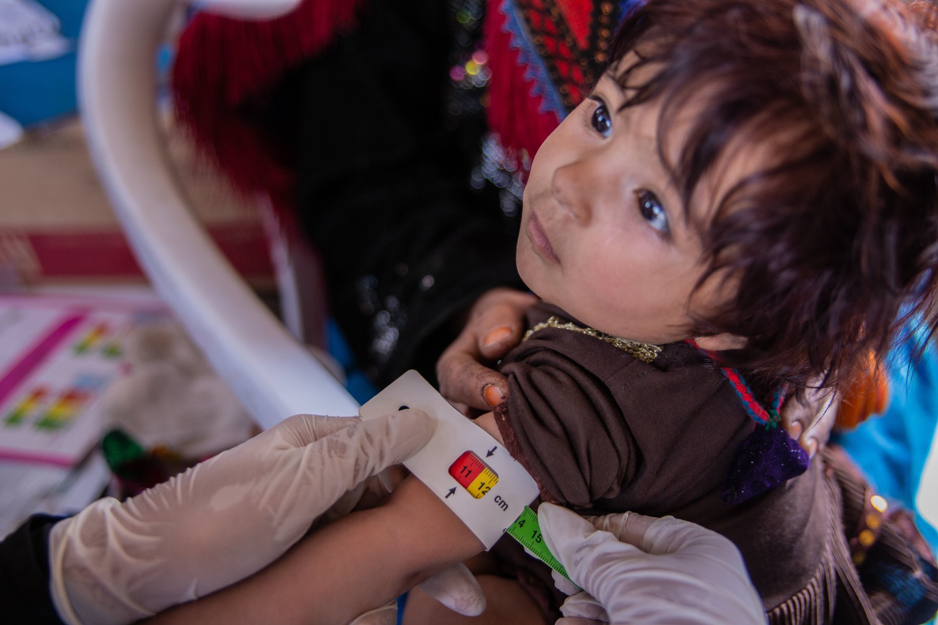 A child with its arm being measured