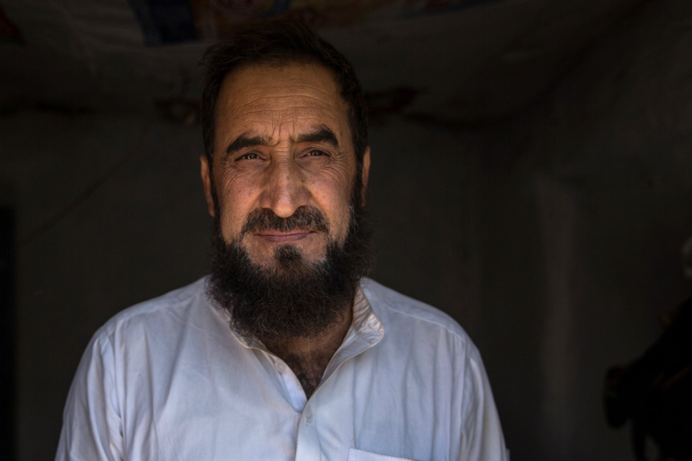 Photo of taxi driver in Afghanistan who has returned from Pakistan, where he owned a shop.