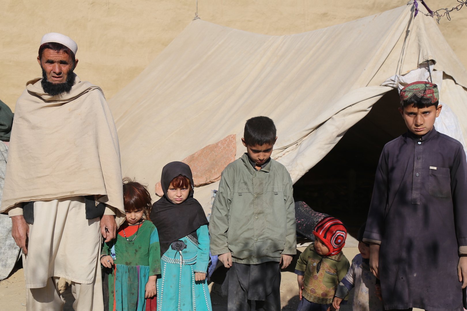 Amir Jan with his children by their tent in Samar Khel, a camp outside Jalalabad where people displaced by war have taken shelter