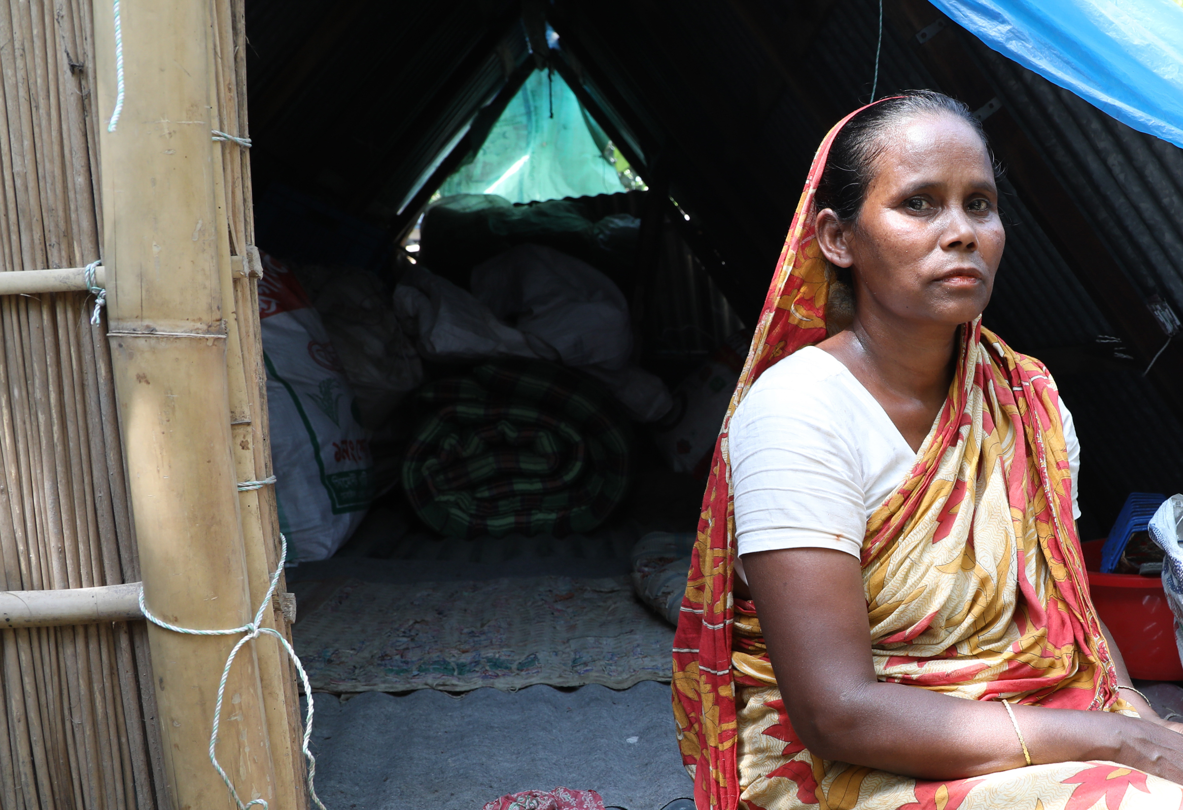 Photo of woman in Bangladesh in the door of her home