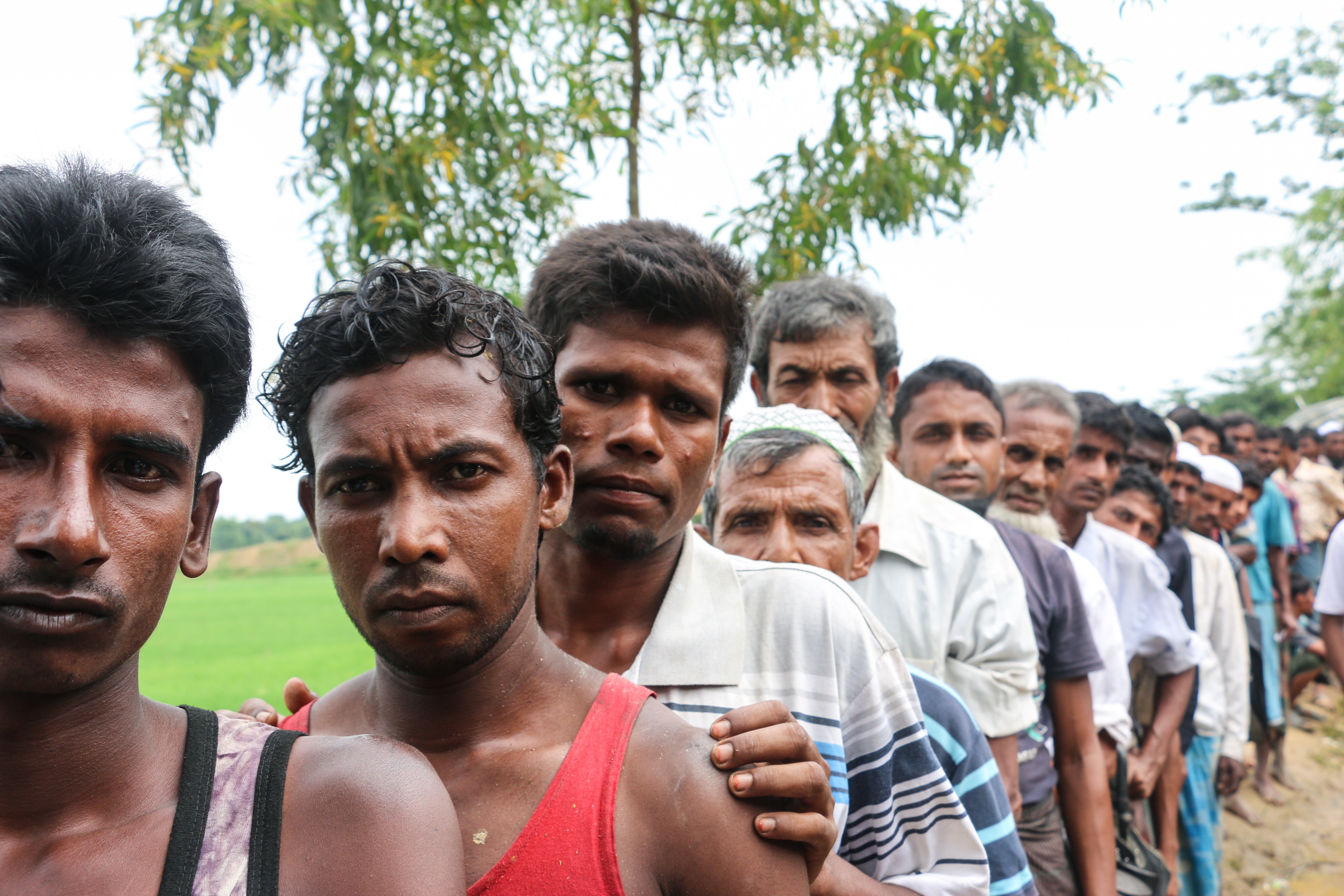 Men line up for aid distribution in Cox's Bazar, Bangladesh.