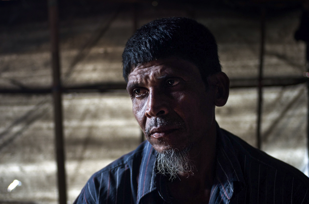 A Rohingya man looks away from the camera