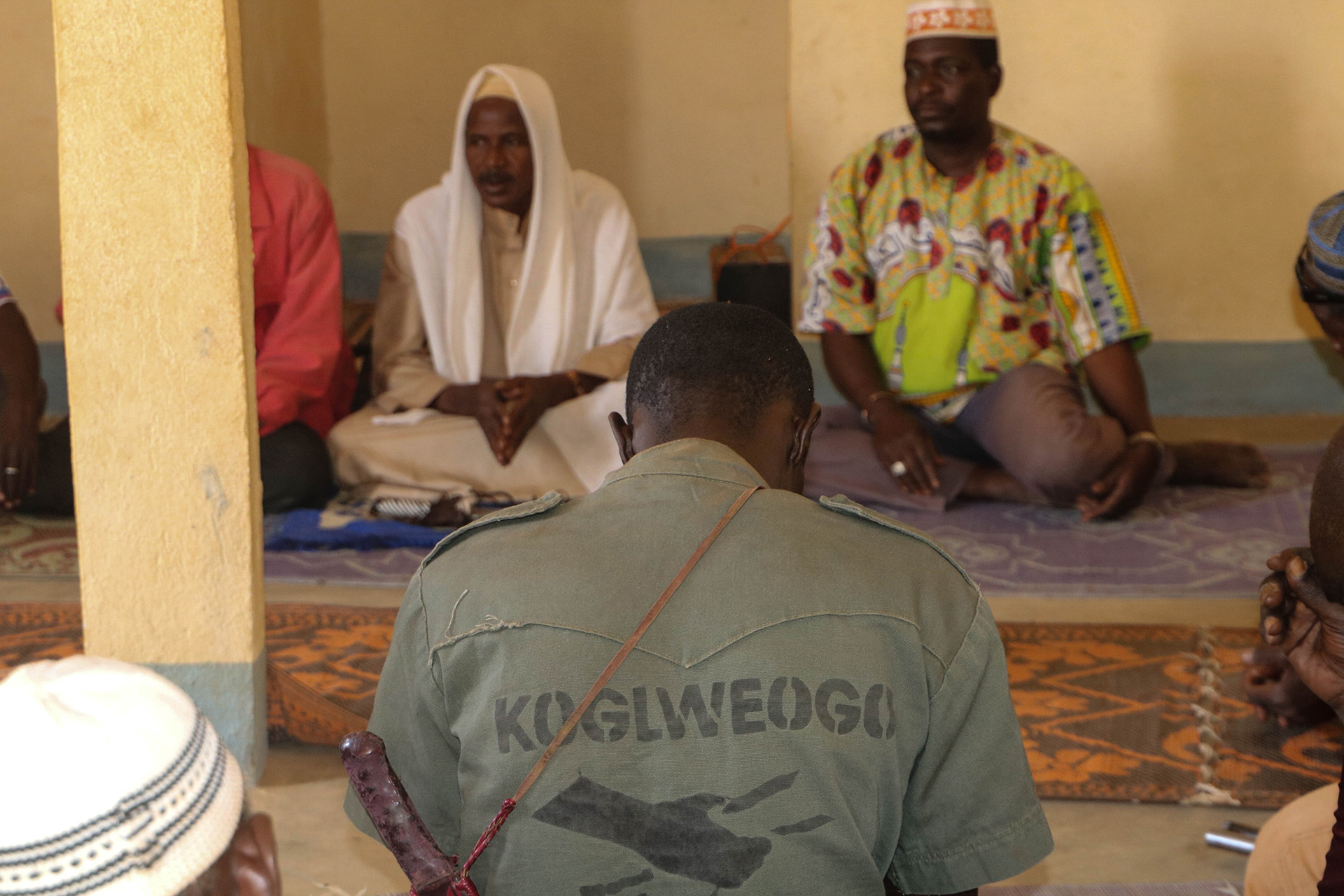 Photo of members of the Koglweogo self-defence group praying together