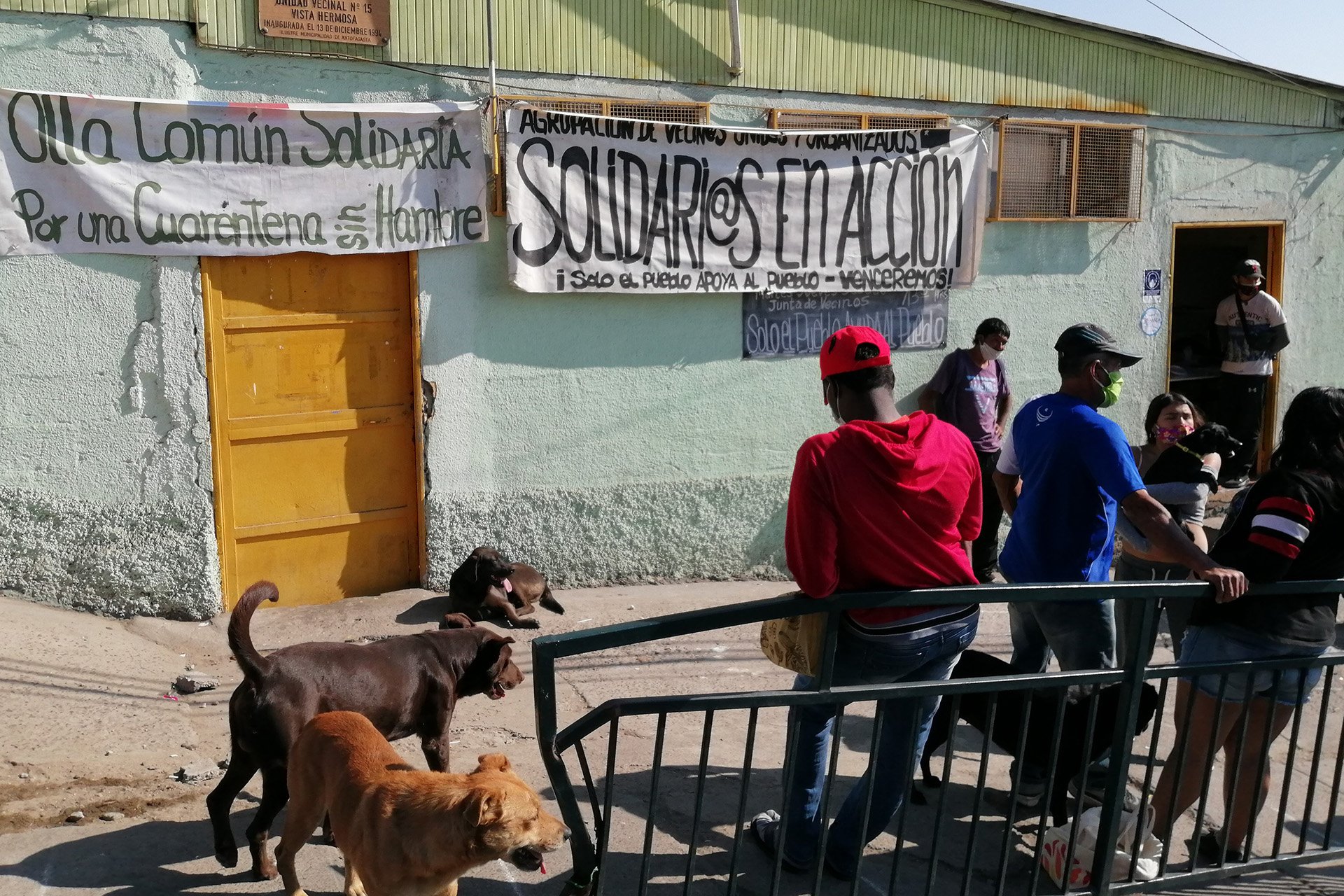 Residents wait to be served lunch at a grassroots soup kitchen during lockdown due to the pandemic in Antofagasta, in northern Chile