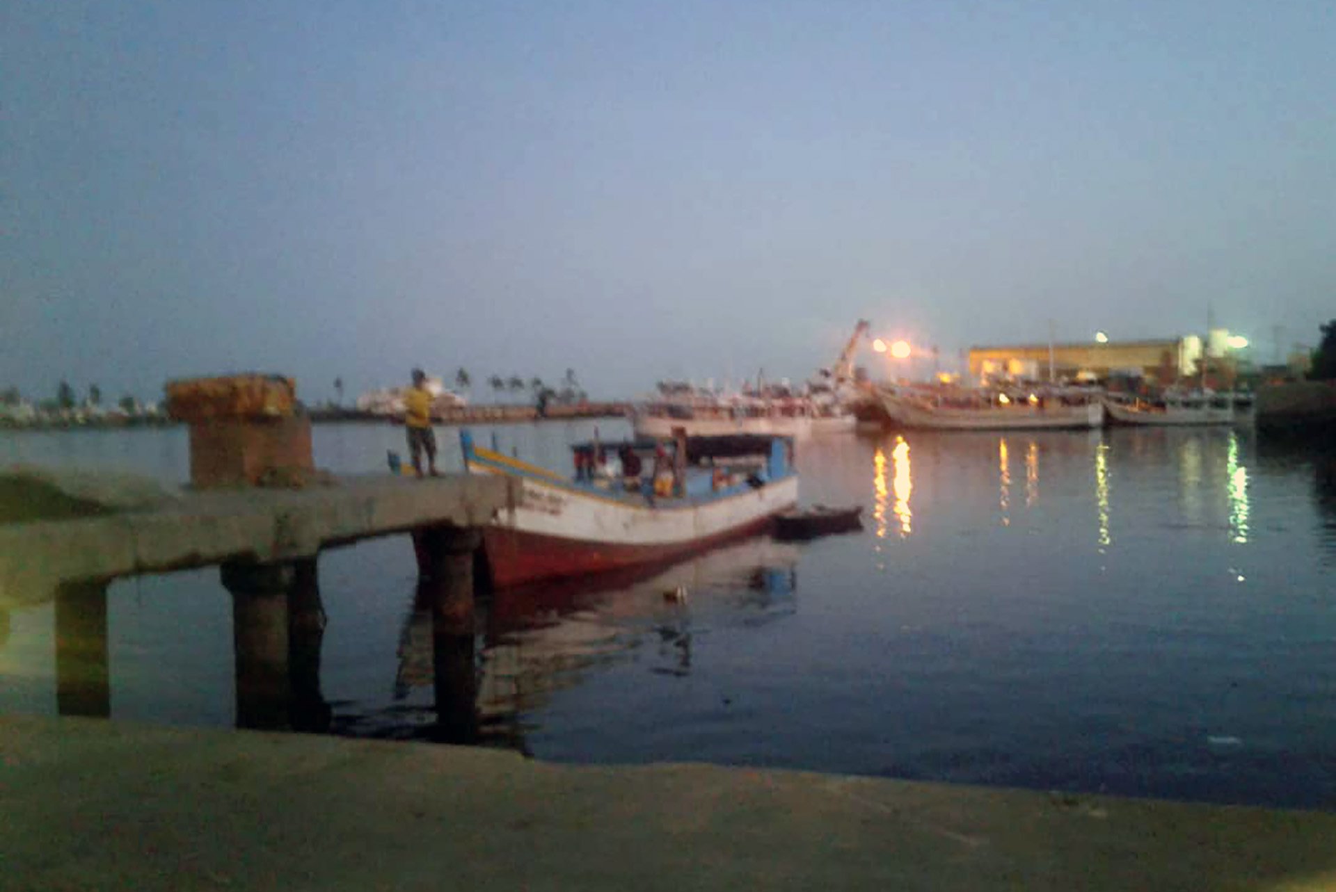 An image shows a port in the evening light