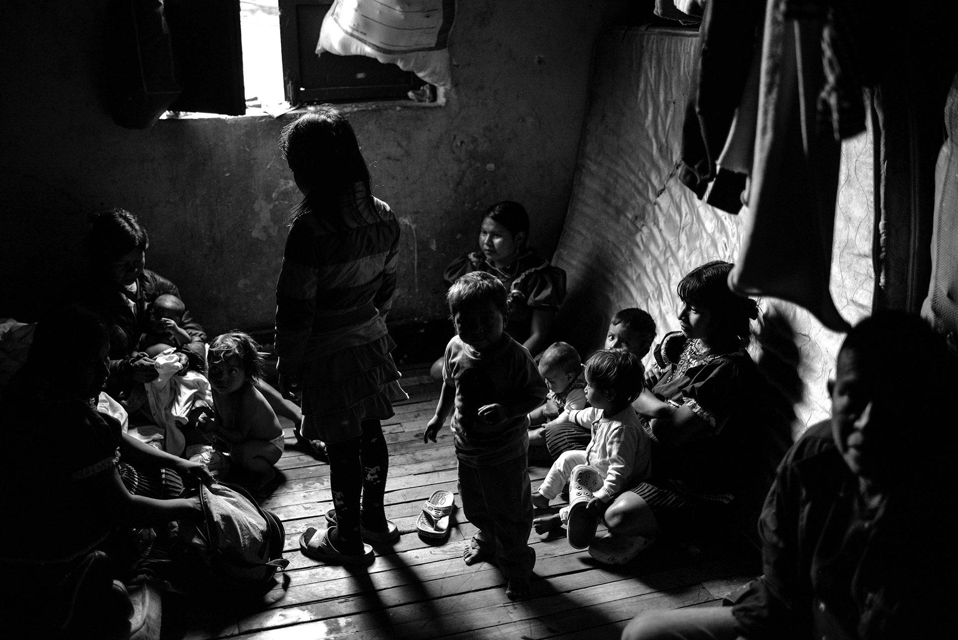 Several members of an Émbera family sleep in a small room of this guesthouse in San Bernardo, a rundown area in downtown Bogotá. Many indigenous families have spent years living in dire conditions after being forcibly displaced from their land.