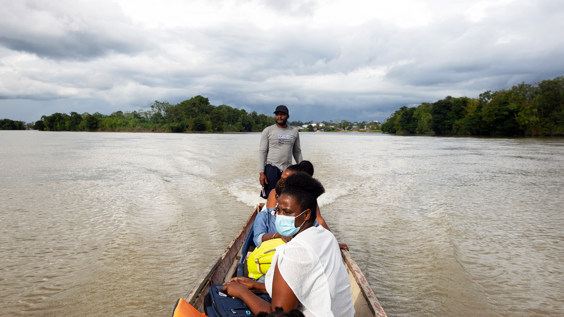 Even accessing victims to offer them support can be hard in remote, violence-prone areas. Here, women's leader Rosa Lozano rides on a wooden boat along the Rio Atrato on her way to help GBV survivors in Colombia's lawless Chocó region.