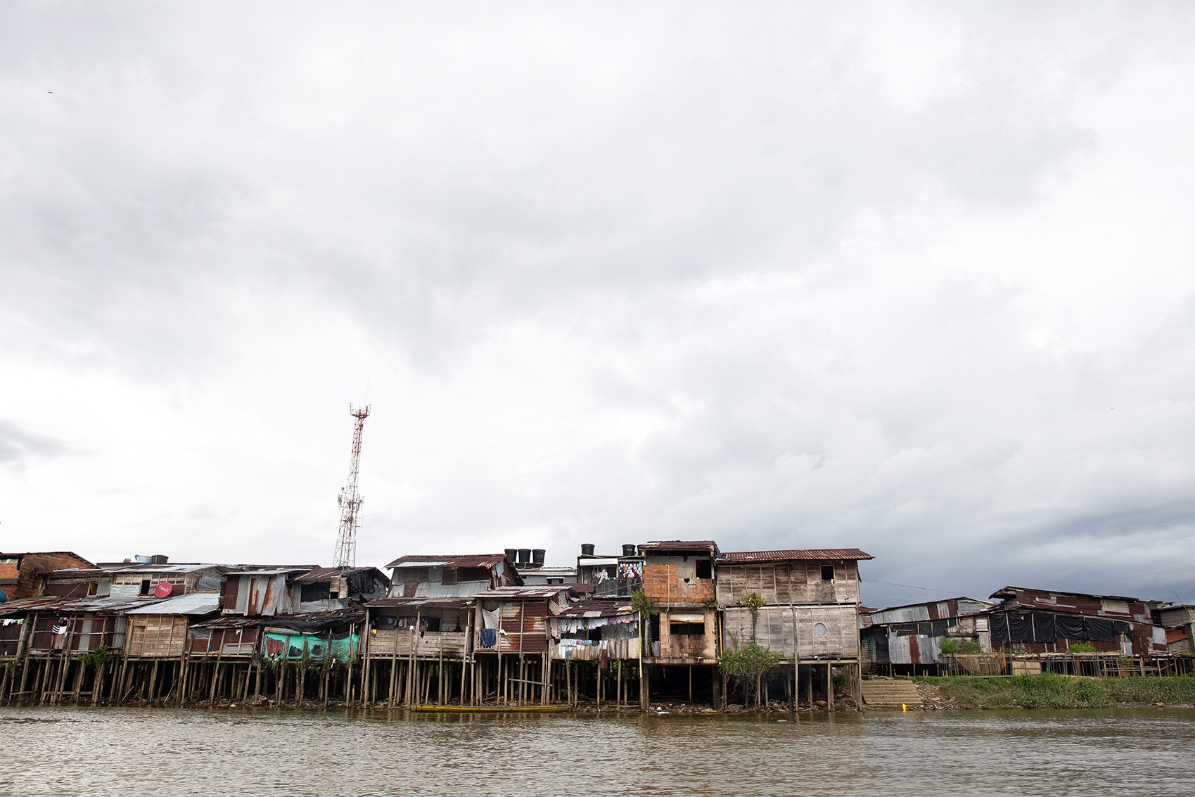 Wooden houses stand over the Rio Atrato, the river that acts as the main transport channel in Colombia’s Chocó region.