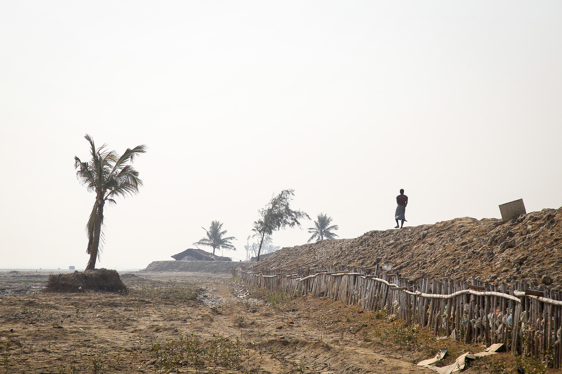 A man walks on a flood bank on Sagar Island, West Bengal