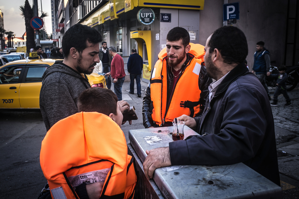 A Syrian refugee buys lifejackets in the streets of Basmane