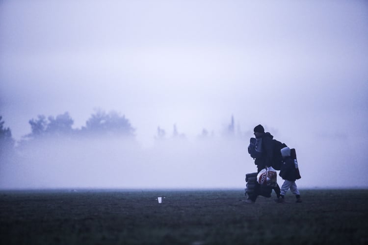 A man crossing the border with his son