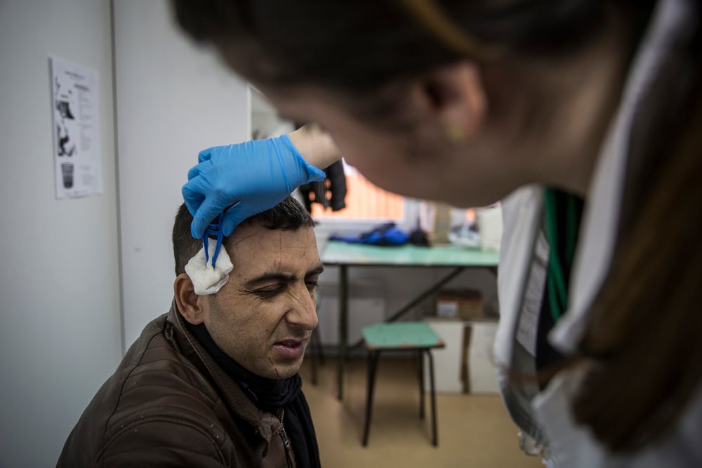 Javed Zamankhil, 24, from Kunduz, Afghanistan, has scratches treated by the WAHA medical team