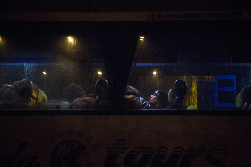 Afghan migrants wait for the bus to depart for Belgrade