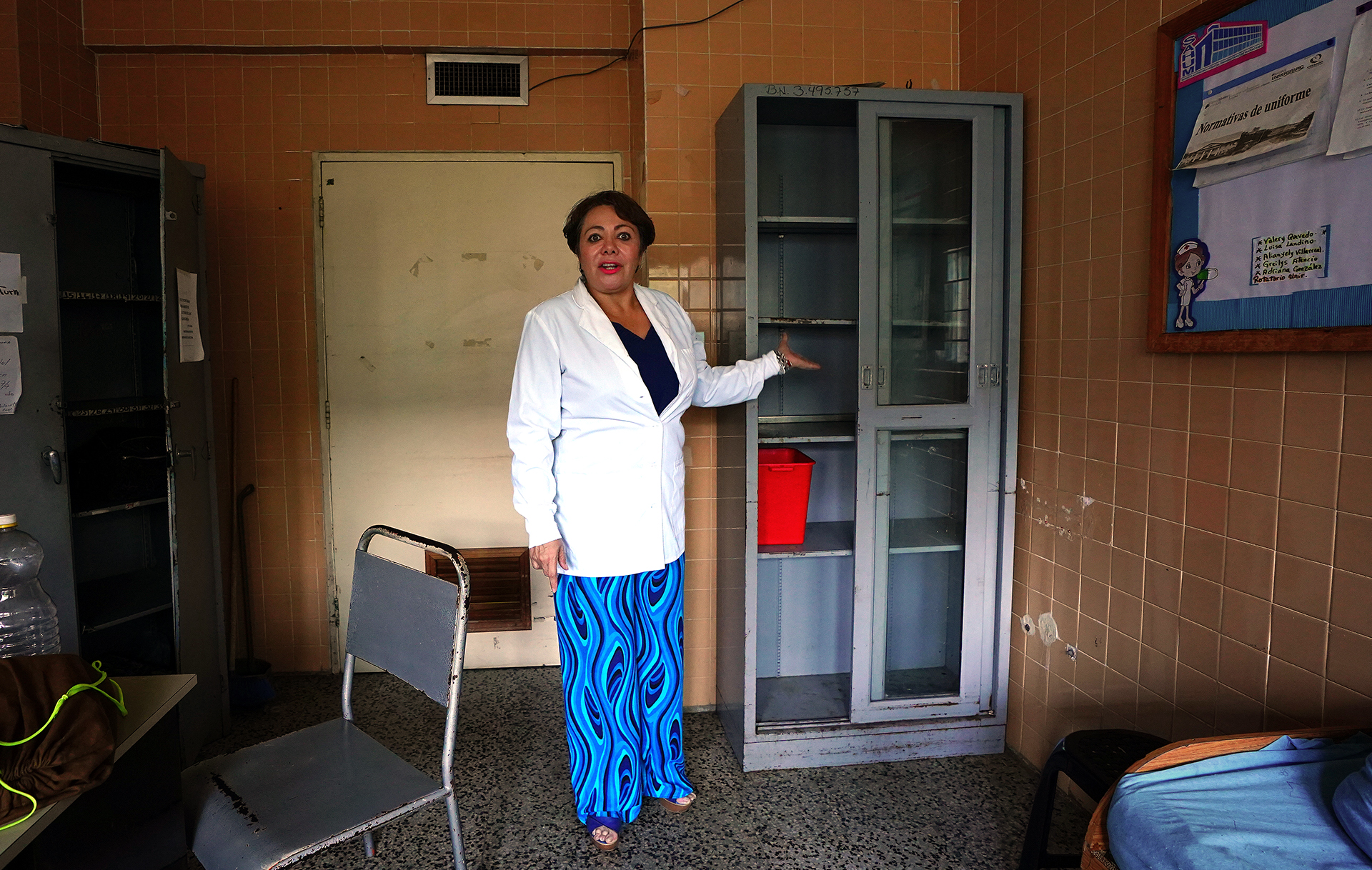 A doctor points to an empty shelf