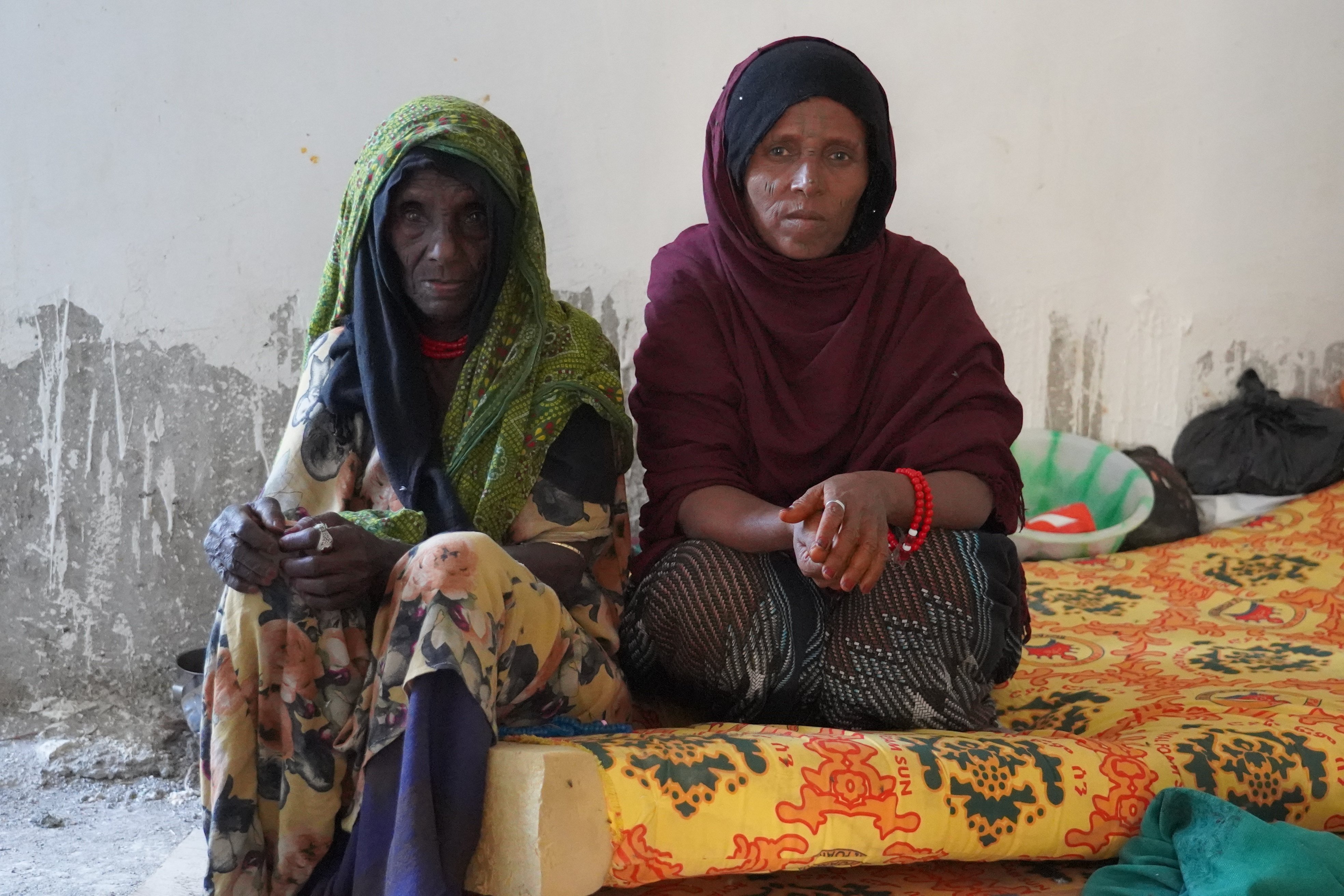 Two women sit on a mattress at Dubti General Hospital in Afar. The health centre has been overwhelmed by patients with serious injuries in recent weeks.