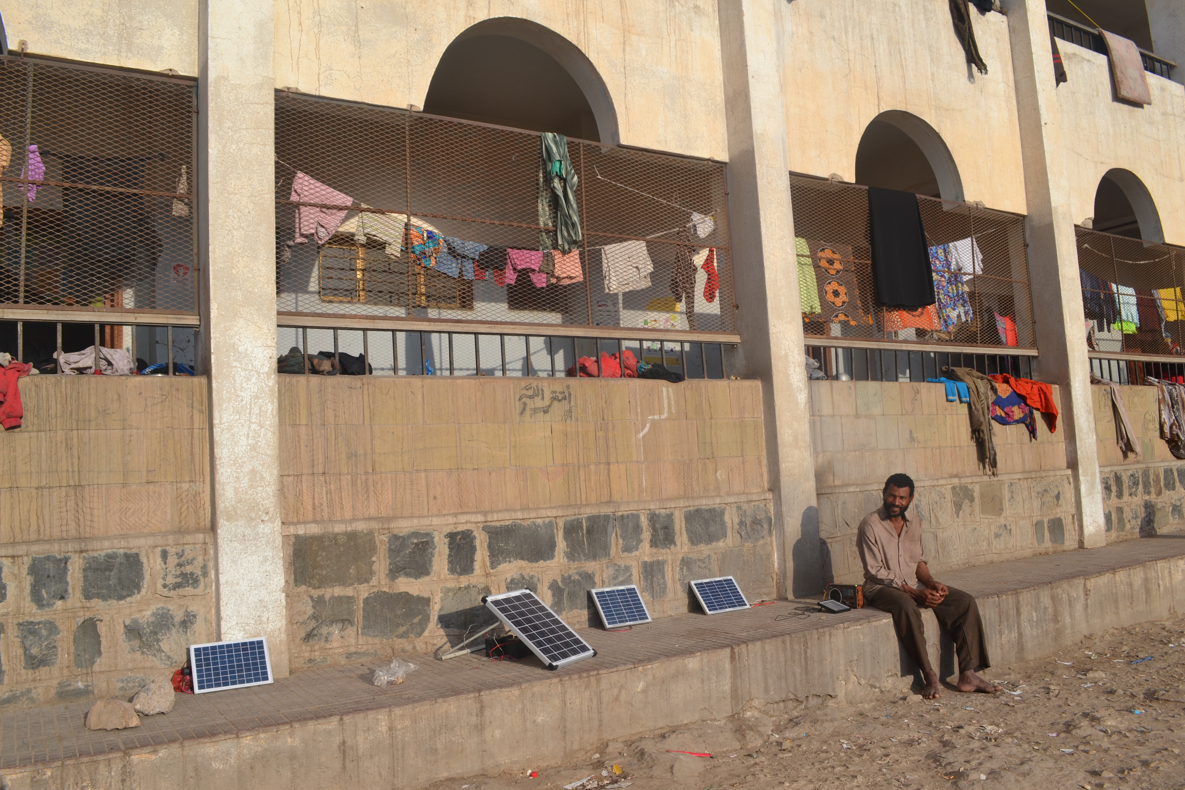 Man sits in a school courtyard