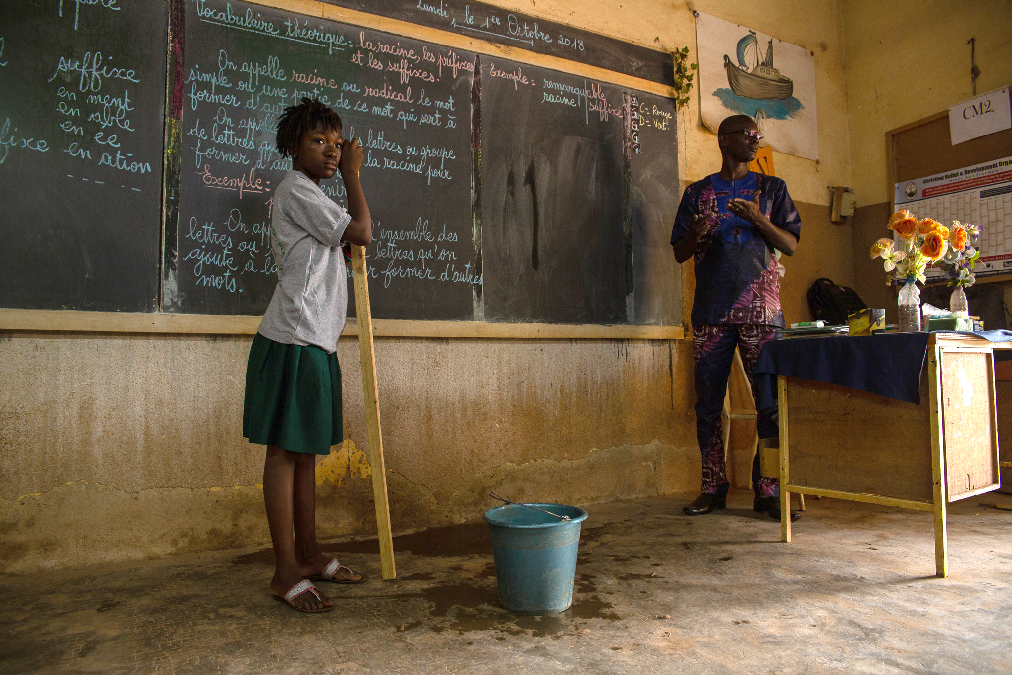 Teachers in front of a chalk board