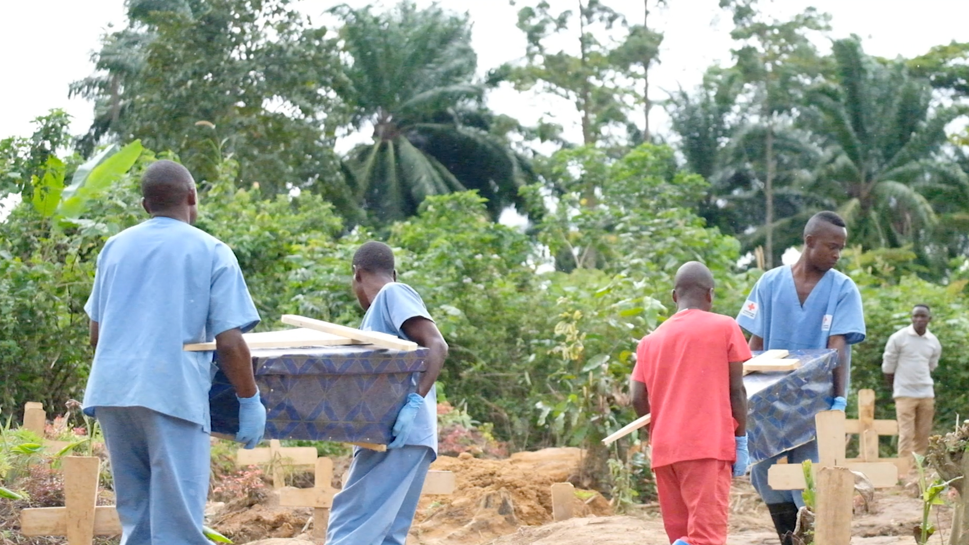 Health workers carry caskets of newborns who died from Ebola in the Democratic Republic of the Congo.