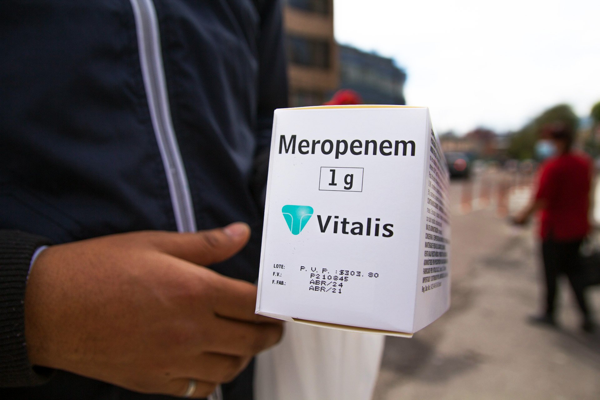 A delivery man brings a box of medication for a Covid-19 patient inside the Carlos Andrade Marín hospital, since the hospital ran out. The medication costs $300, which the patient will have to pay themselves, and will likely only last three days.