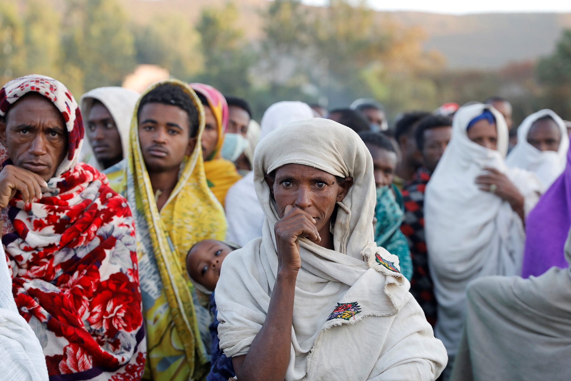 A woman stands in line to receive food donations at a temporary shelter for people displaced by conflict in Shire on 15 March, 2021.