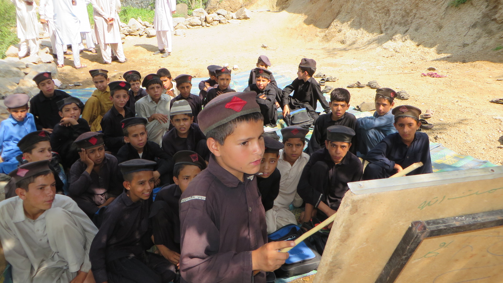 Children studying in an open air school in the town of Mamund