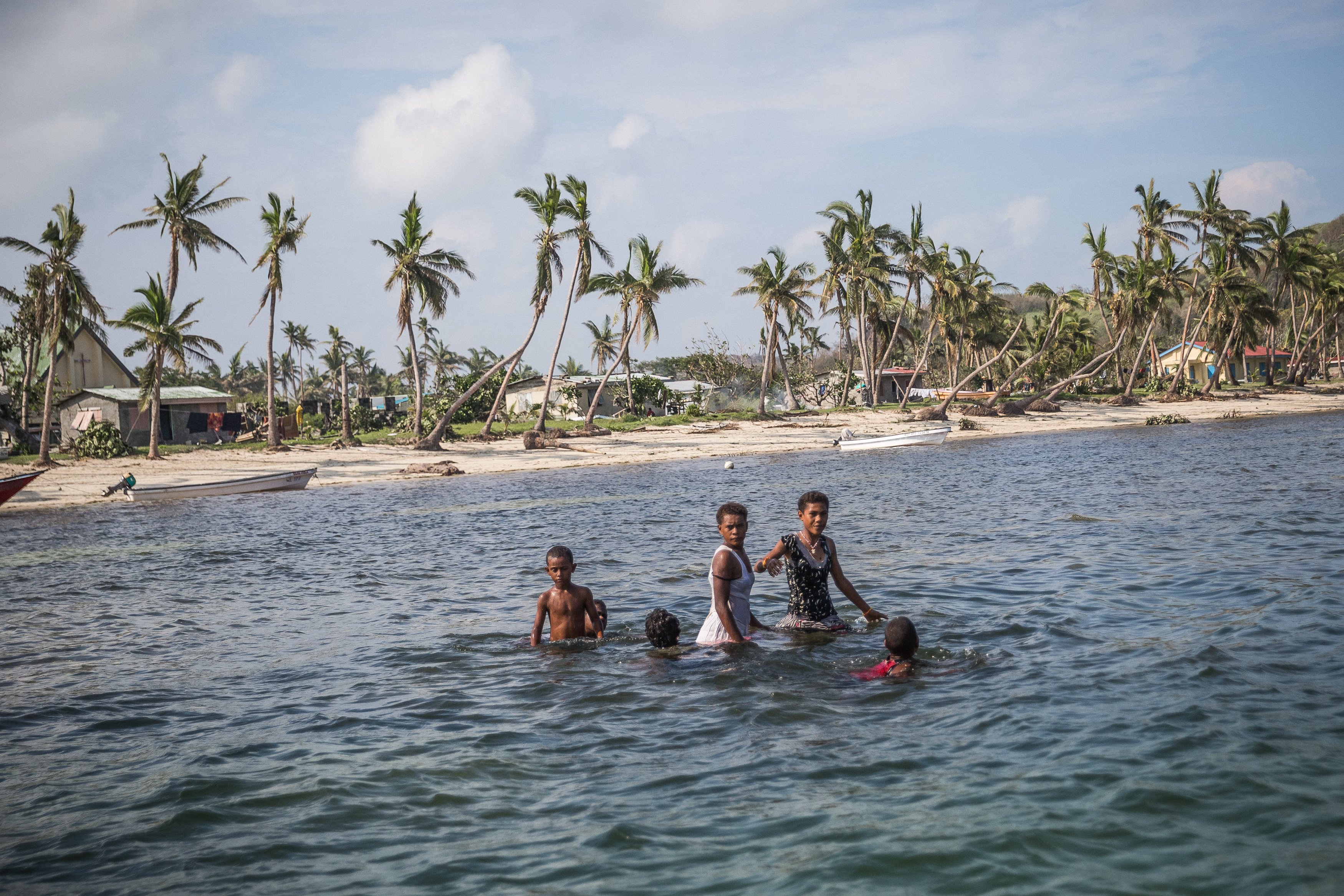 Children play in the ocean