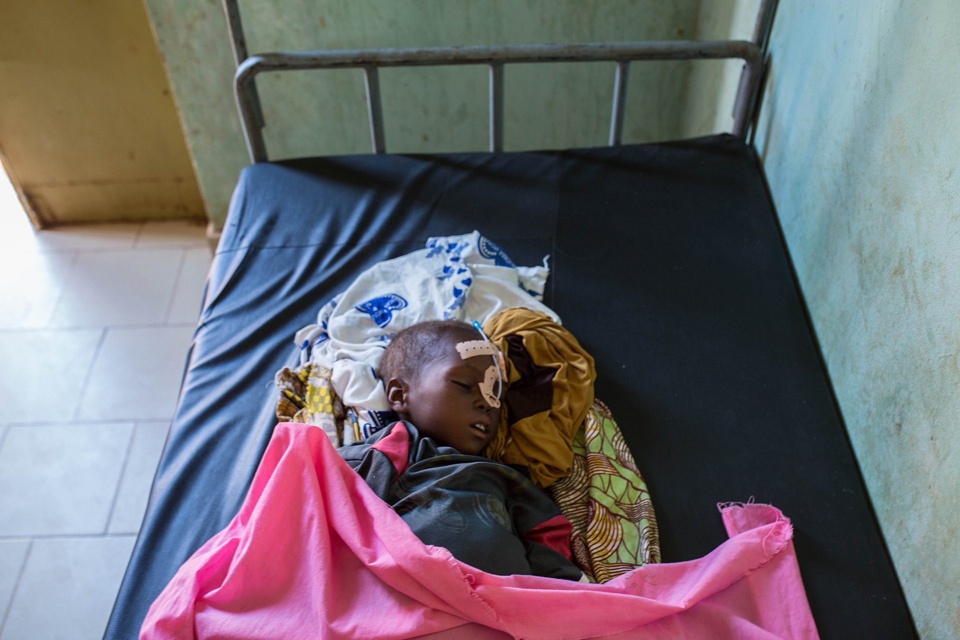 A young child with medical equipment on a bed