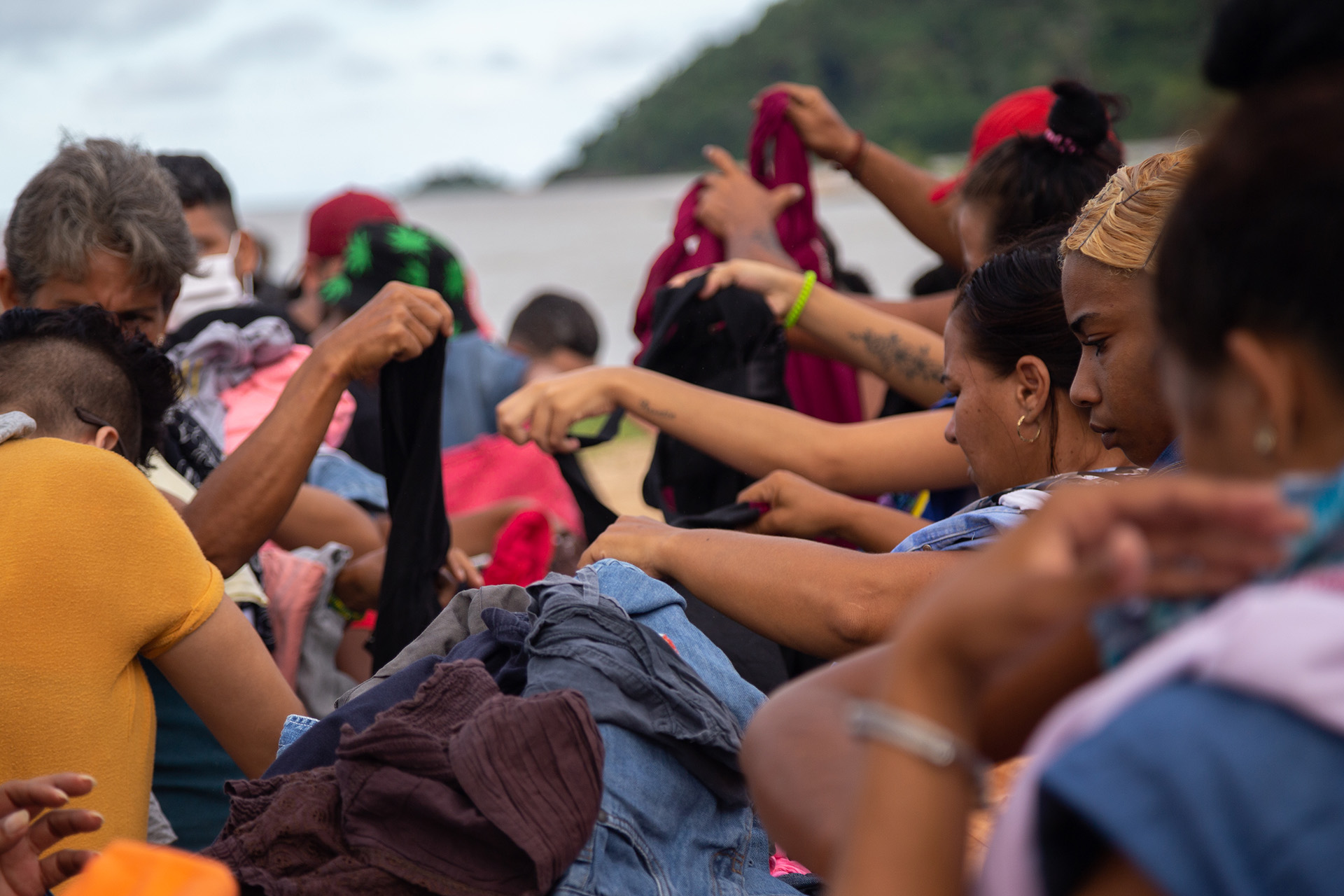 Cuban migrants are pictured sorting through donated clothes.