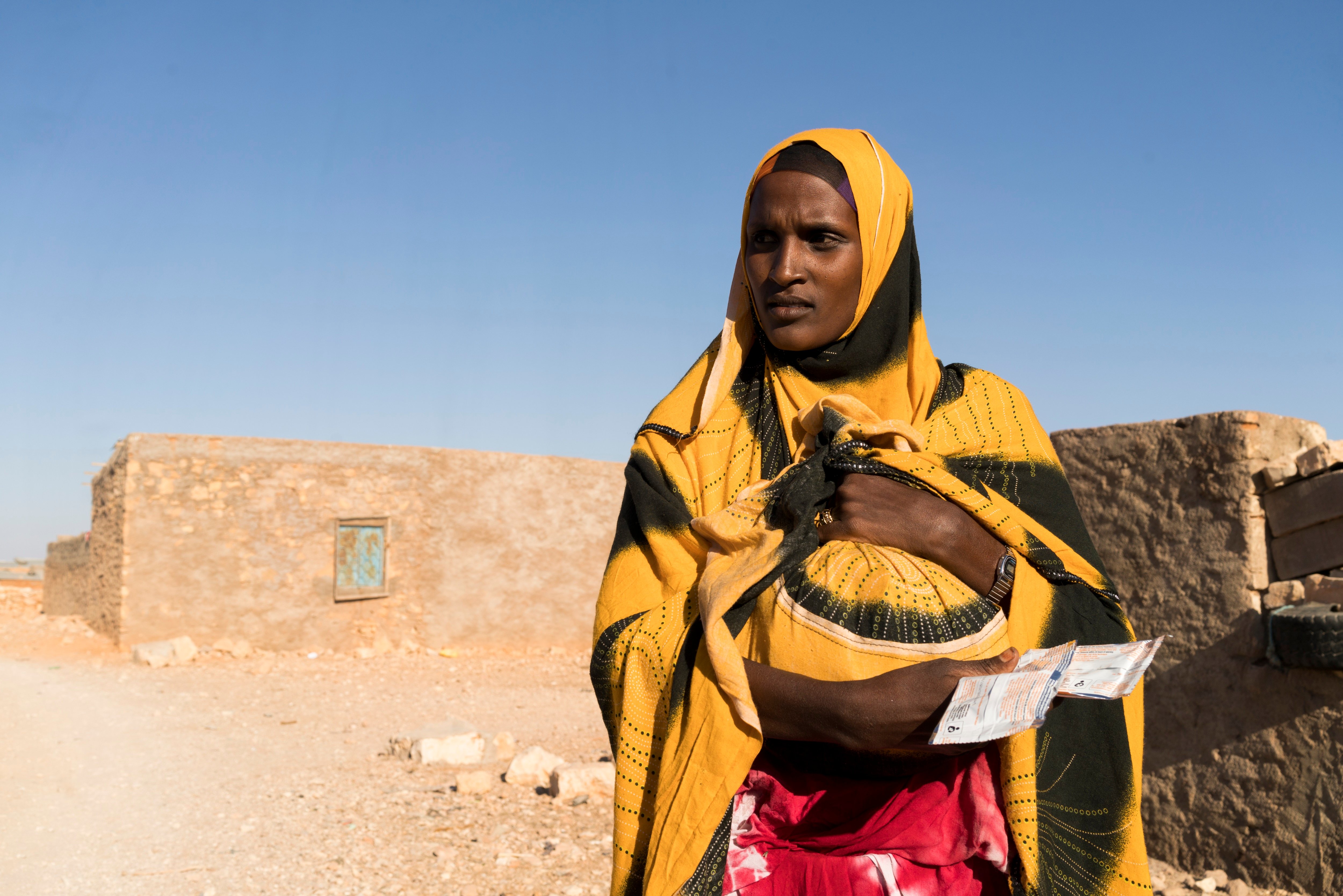 Mother with a bundle of supplementary food Puntland