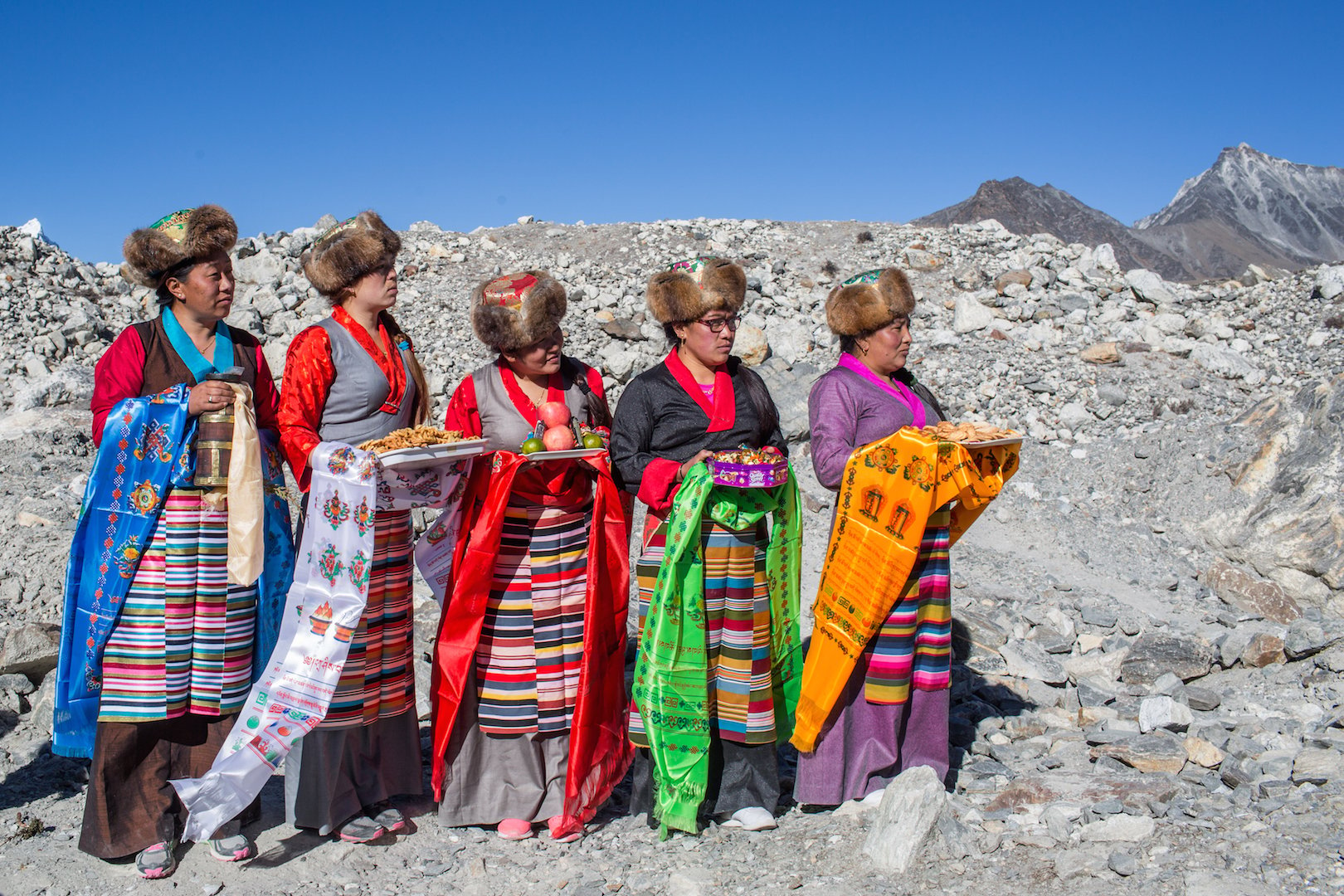 Sherpa women in traditional attire take part in a ceremony to celebrate the completion of a project to lower the water level in Imja Lake