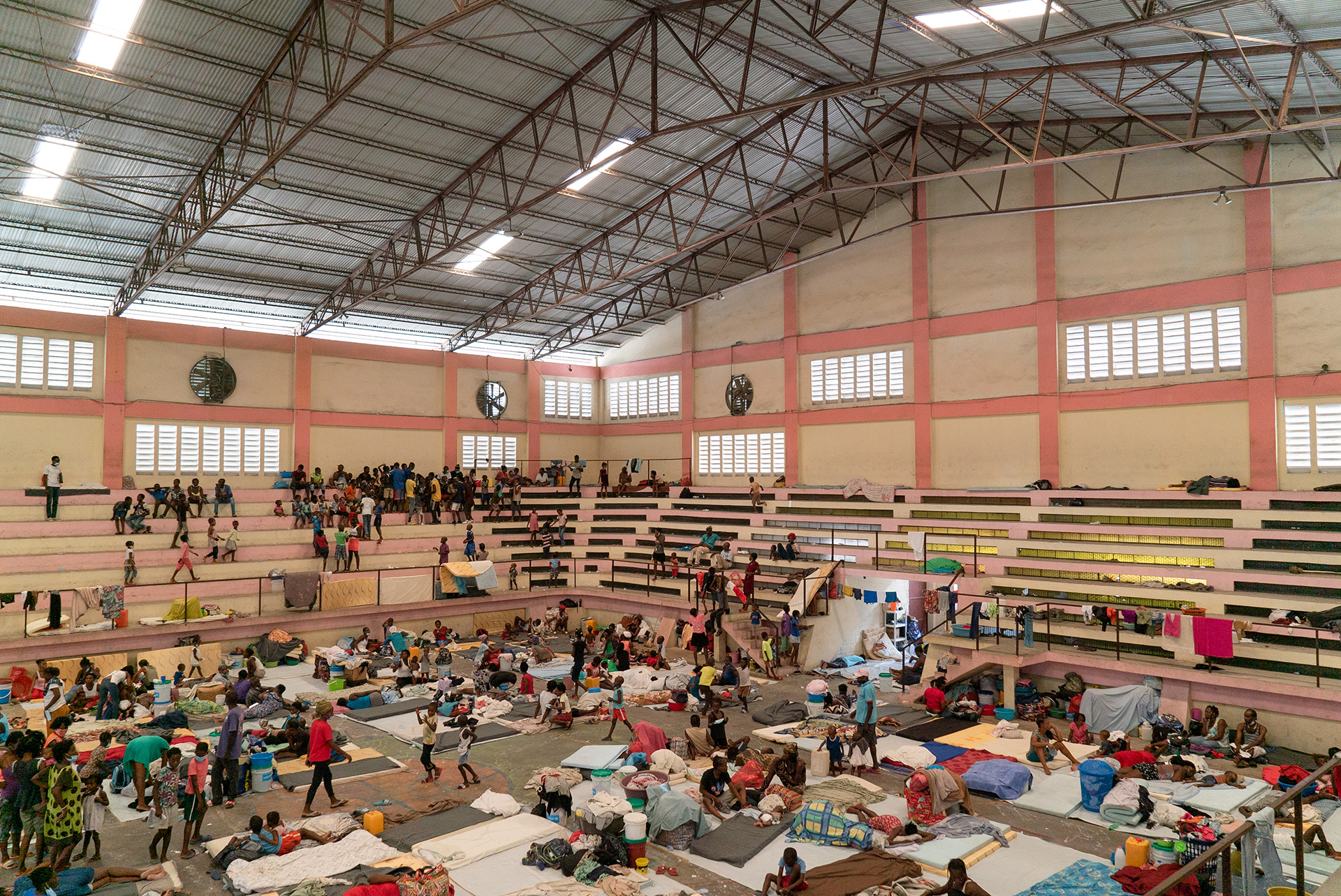 More people have turned to cramped shelters after being displaced by gang violence. Cases of COVID-19, meanwhile, are quickly climbing in the Caribbean country.