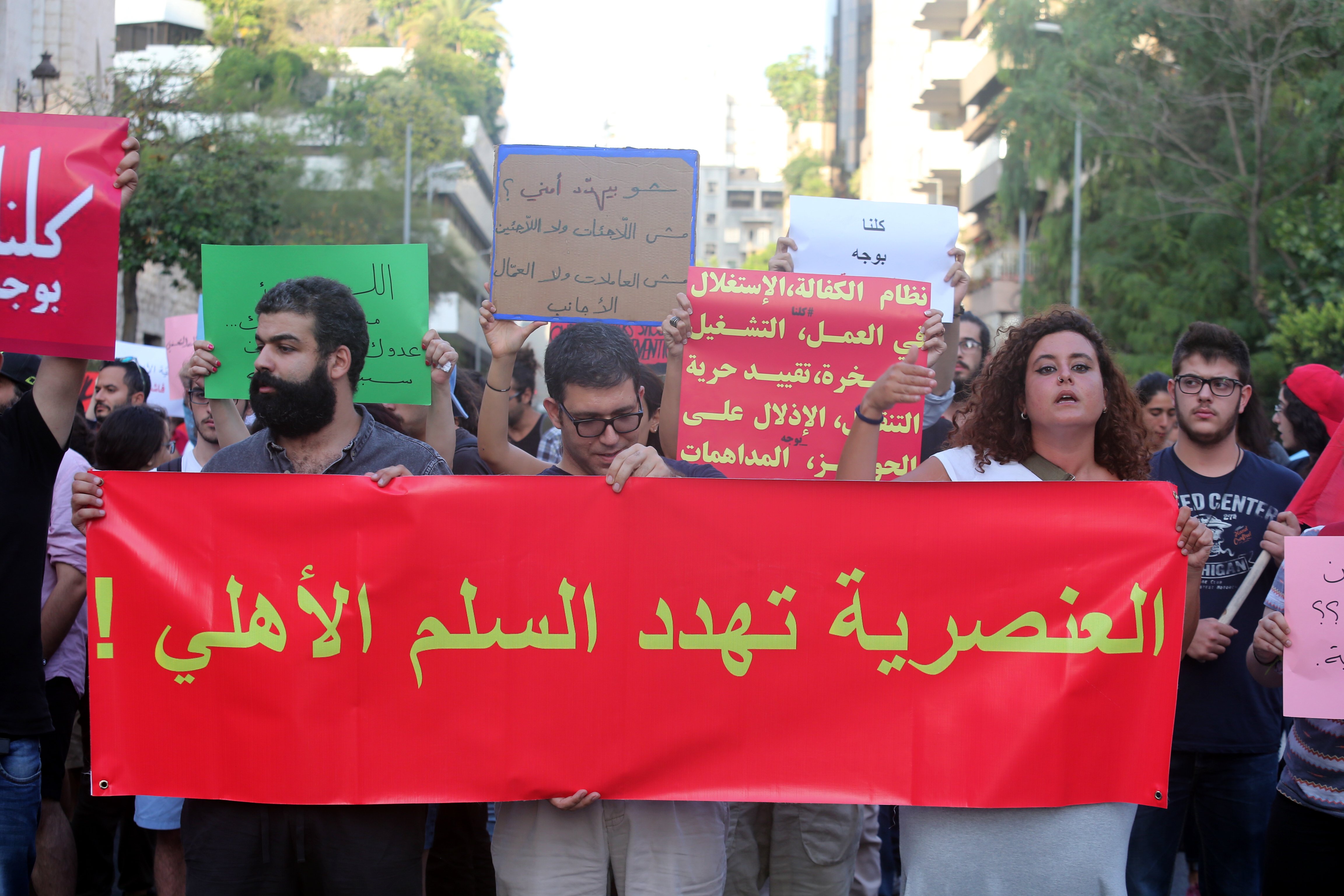 Protestors hold a banner