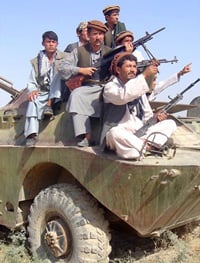 Armed men on top of an armoured vehicle, Kabul, Afghanistan, 10 December 2003. The rule of gun is stronger as the first months after the Taliban collapse.