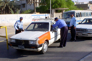 [Iraq] Police officers conducting a routine security check in Basra.