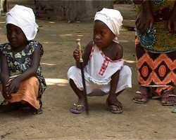 [Sierra Leone] A small girl from Sierra Leone carries her ceremonial knife. At her 5 years old she is learning how to become a circumciser to provide income for her family.