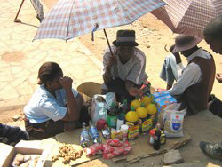 [Zimbabwe] Tracy with her daughter attending to a customer.