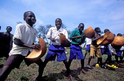 [Uganda] School boys rehearse for a musical performance in an internally displaced persons’ (IDP) camp in Alero District in northern Uganda, August 2006. With calm returning to most parts of northern Uganda, children are now able to experience a normali