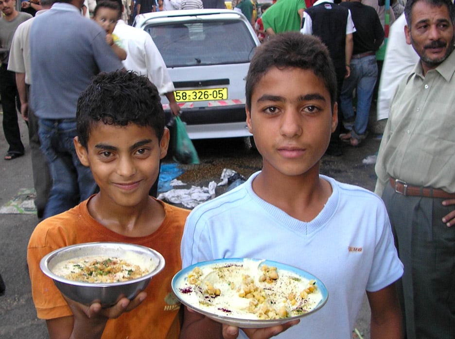 Palestinian children from the Balata refugee camp near Nablus hold plates of Hummus, Occupied Palestinian Territories, September 2006. The World Food Programme (WFP) has warned that almost half of all Palestinian face food insecurity.