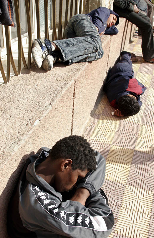 Street children sleep outside a day shelter in Giza, Egypt, 12 February 2007. Children living and working on the streets are vulnerable to violence, exploitation and substance abuse. Many turn to drugs to cope with their situation.