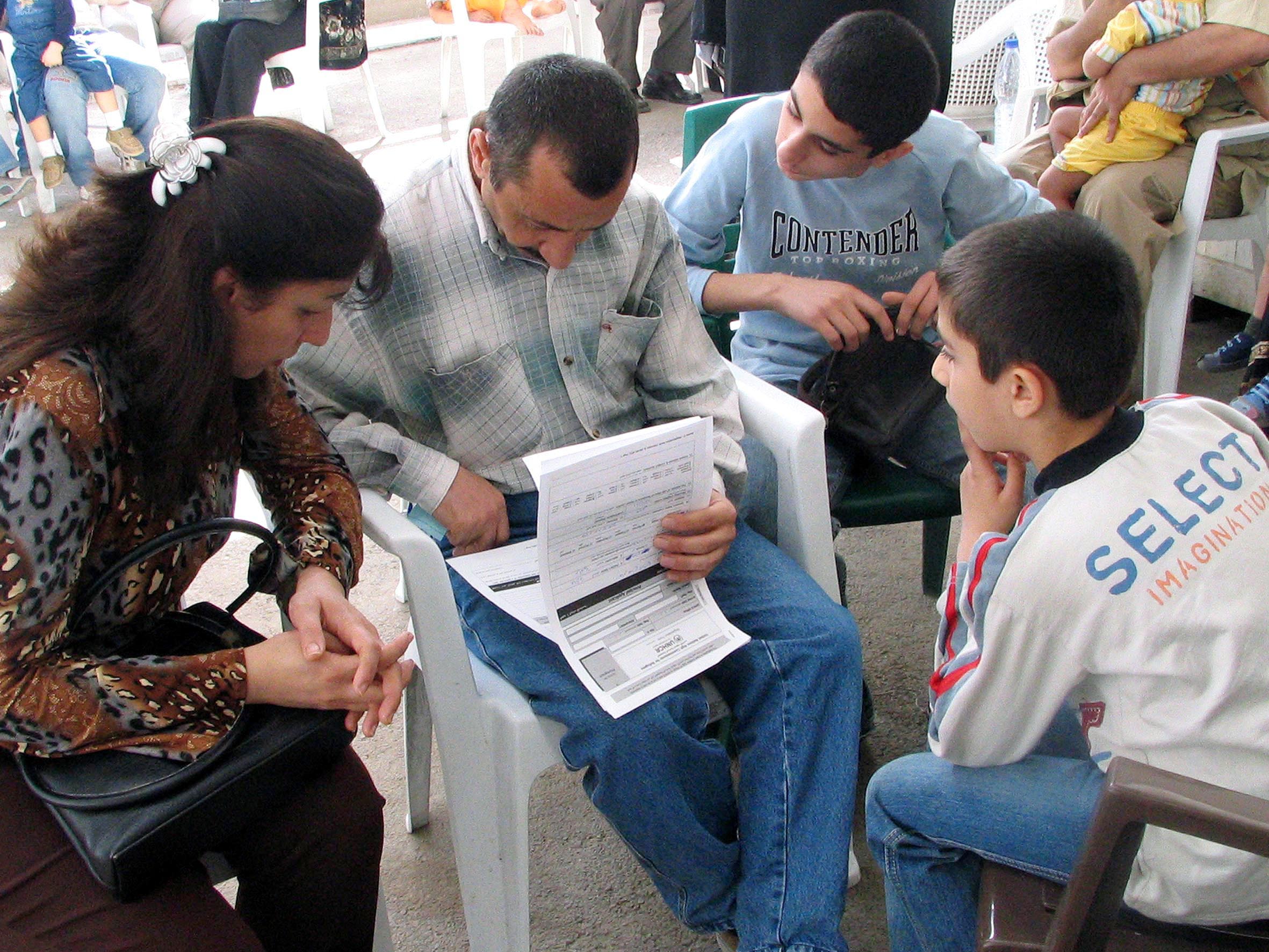 An Iraqi family fills out their form to register as refugees at the UNHCR’s new centre outside Damascus.