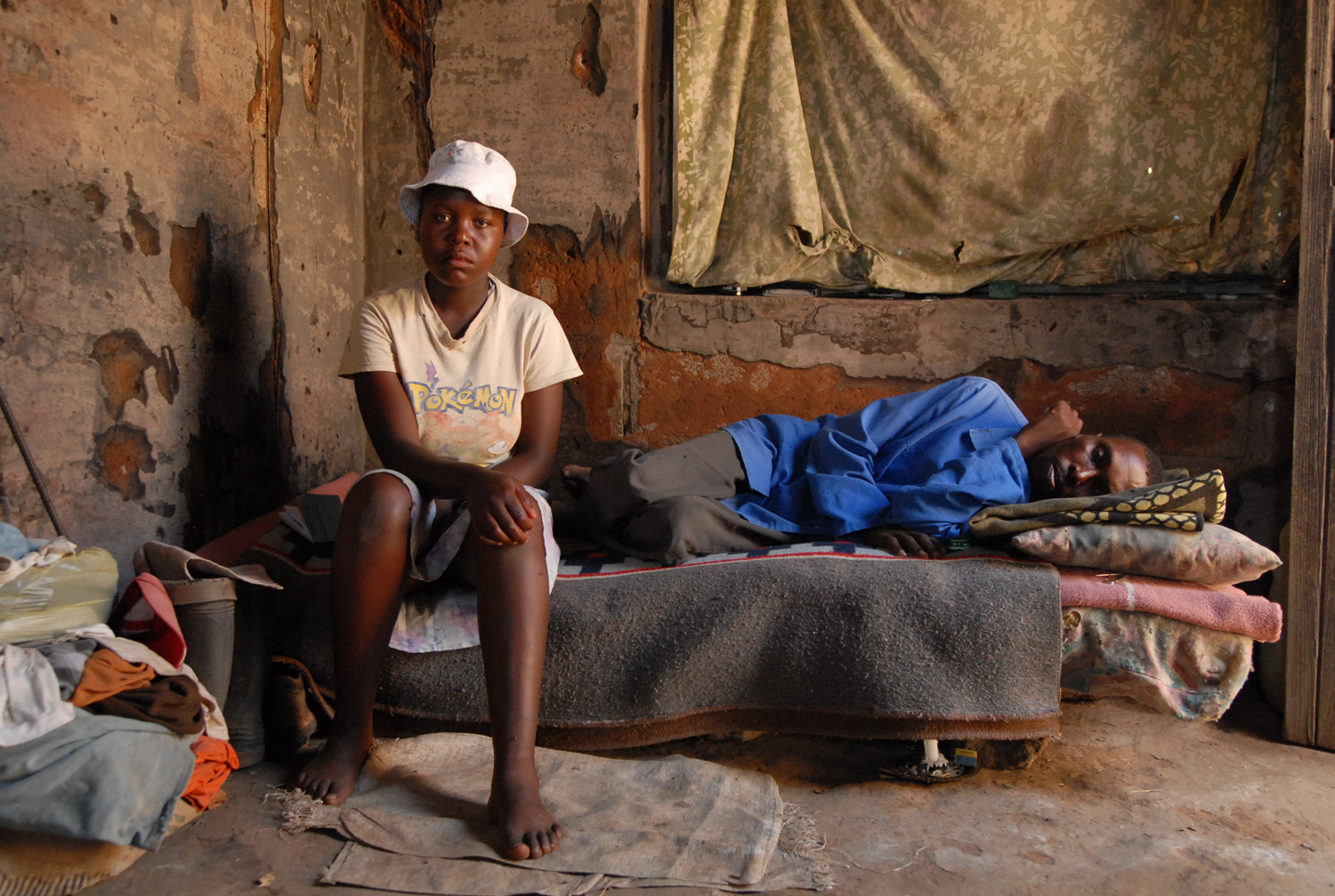 Mamaribe Hata-Hata, 17, and her father Ramarumo Hata-Hata, who has just tested positive for HIV. 20 June 2007. As her mother is dead, and her father's new partner also died two years ago, Mamaribe is the only one left to take care of him when he is sick