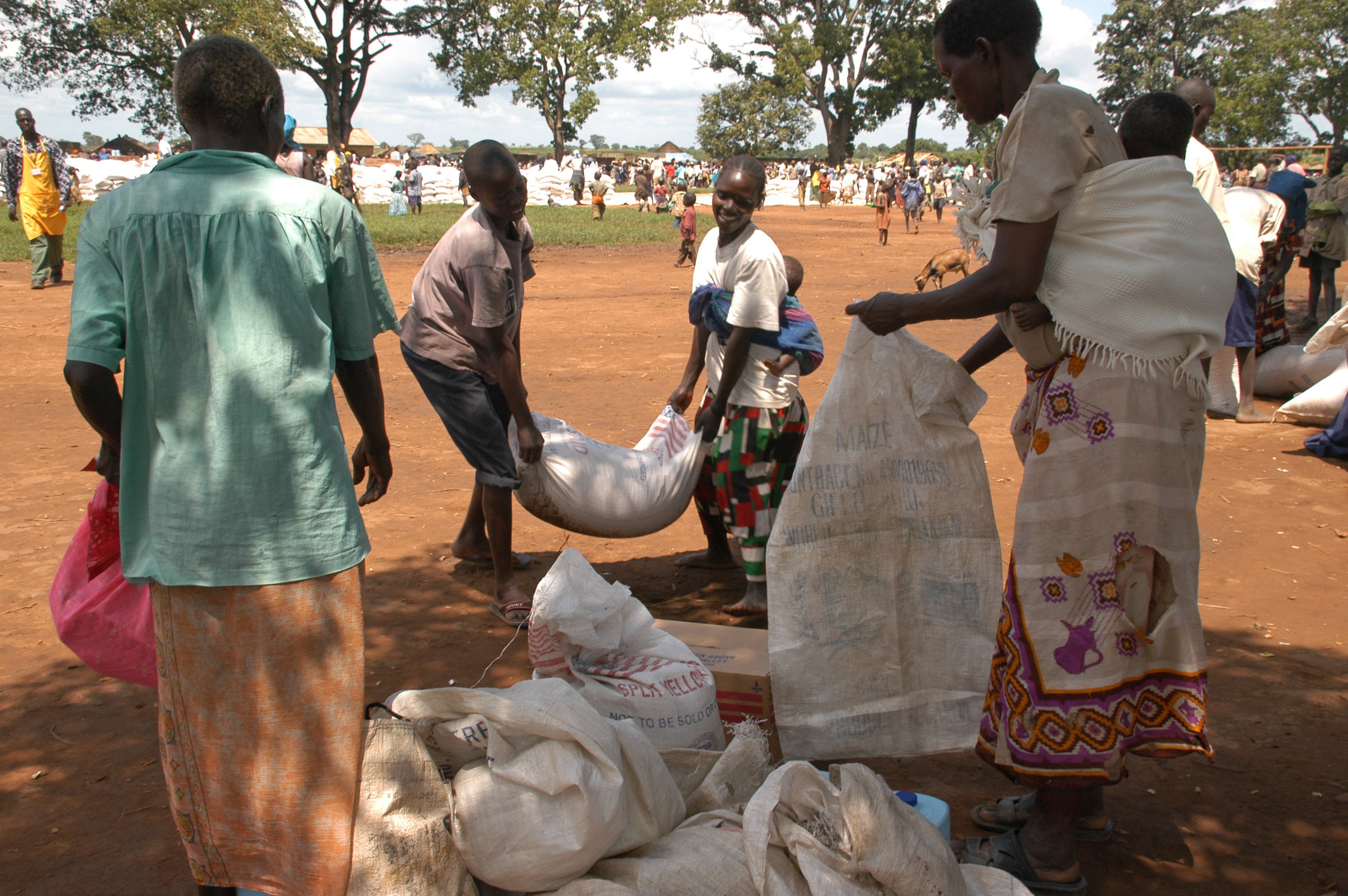 Regina prepares the family's share of food from WFP during the distribution of the return rations on 7, August, 2007, at Awer camp of the displaced. Thousands want to return, but few would venture out as families are divided over the returns.
