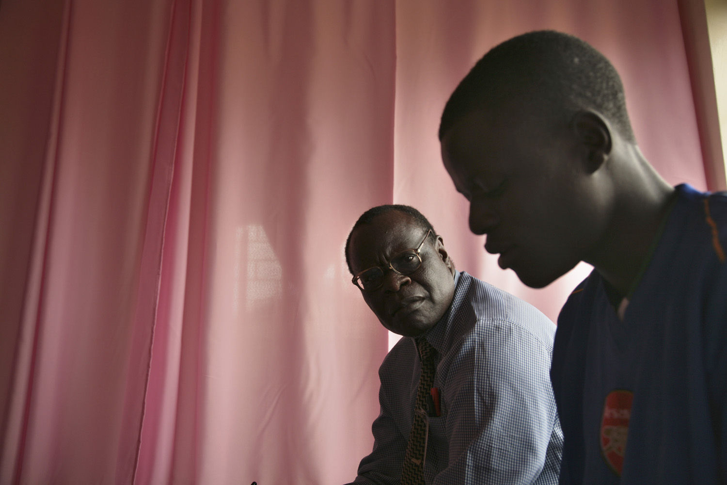 Dr Tom Oyok is mentioned in the mental health article and here he can be seen speaking to a pupil at Laroo Boarding School near Gulu.