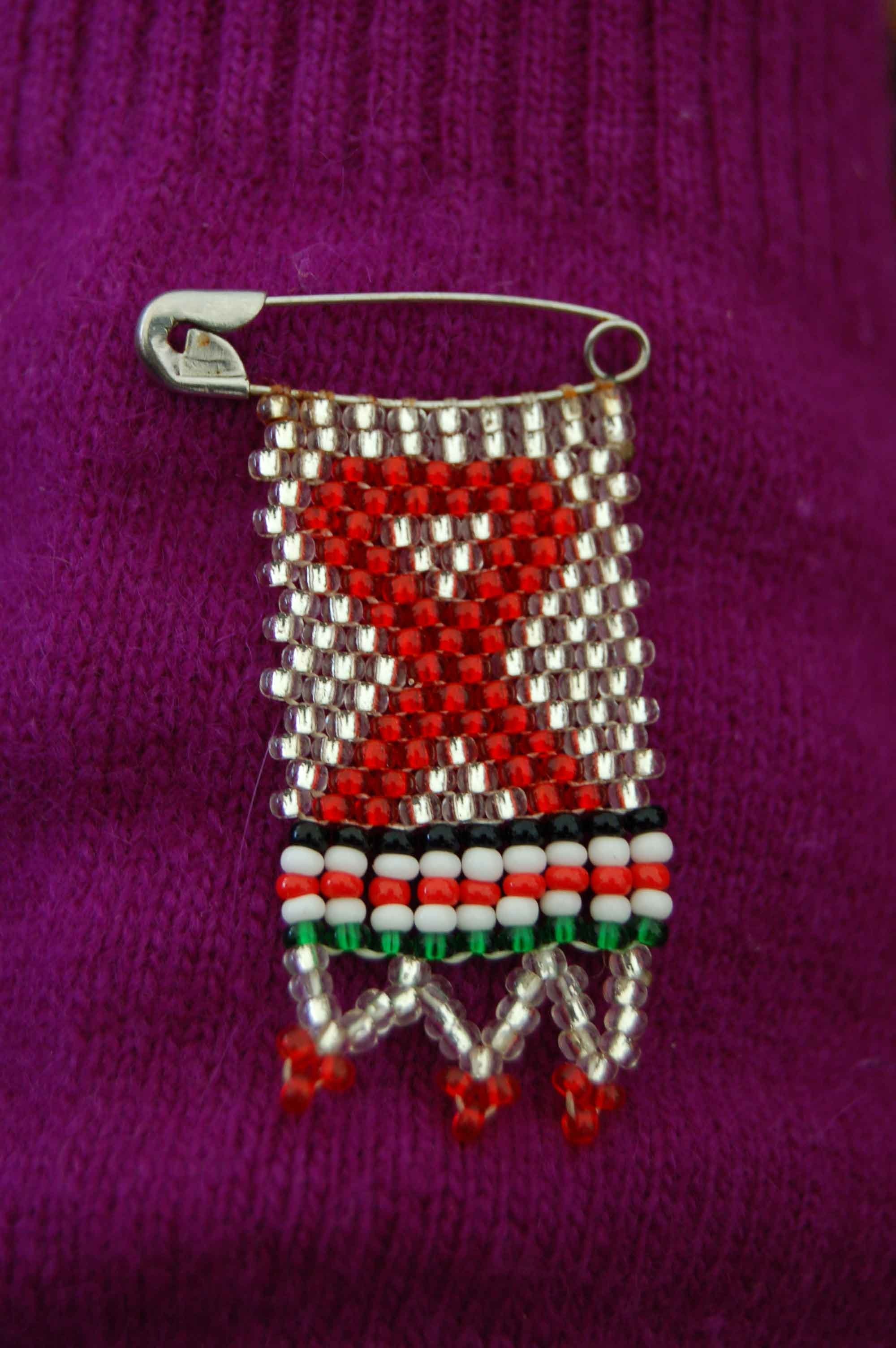 Red ribbon on a pin.