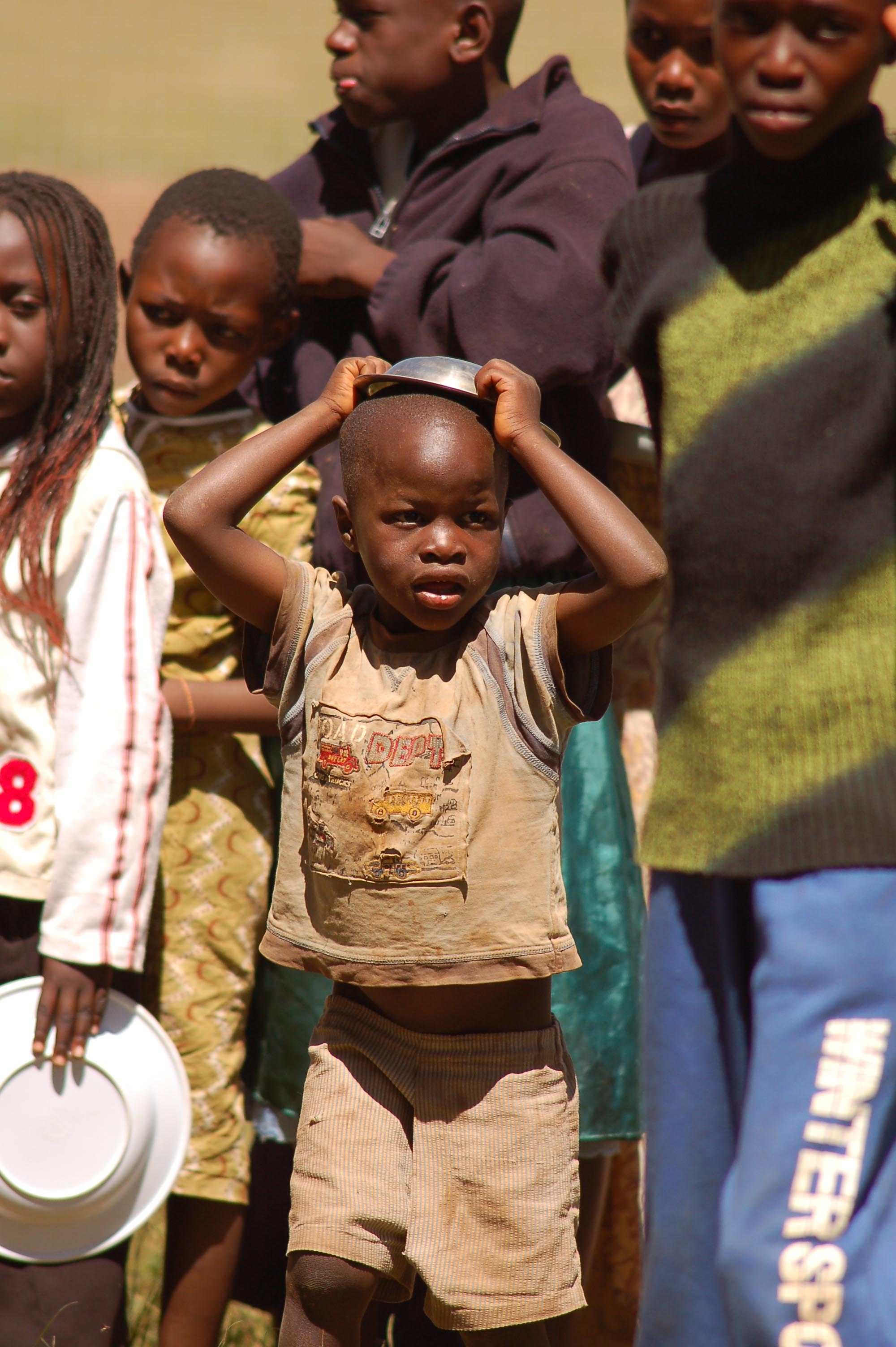 An internally displaced child lines up to get food aid at the Thika stadium, Kenya. Many people have been displaced as a result of the post election violence.